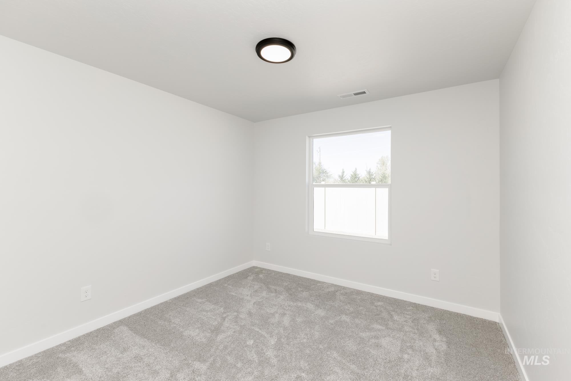 Unfurnished room featuring carpet and baseboards