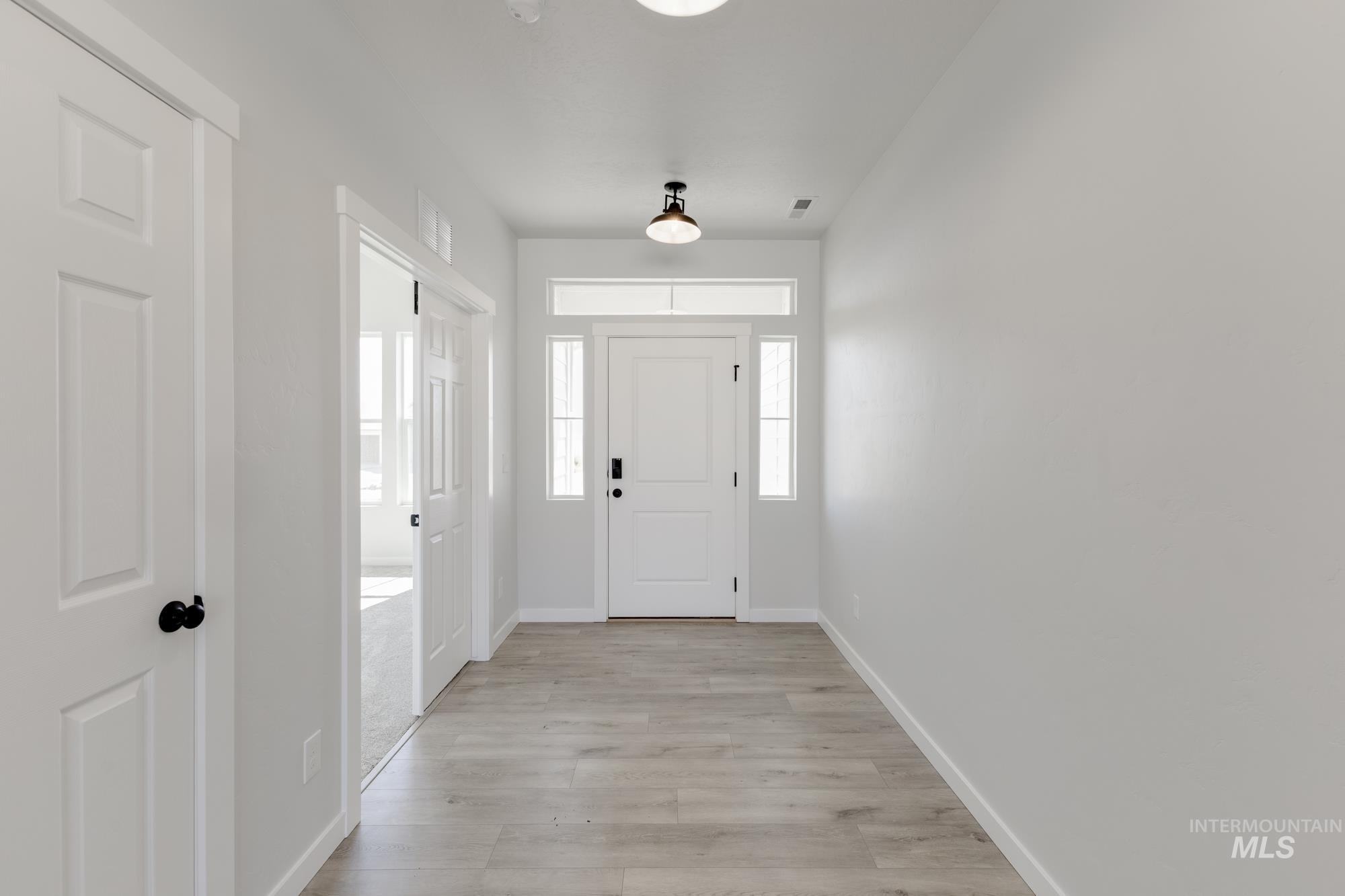 Entrance foyer with light wood finished floors