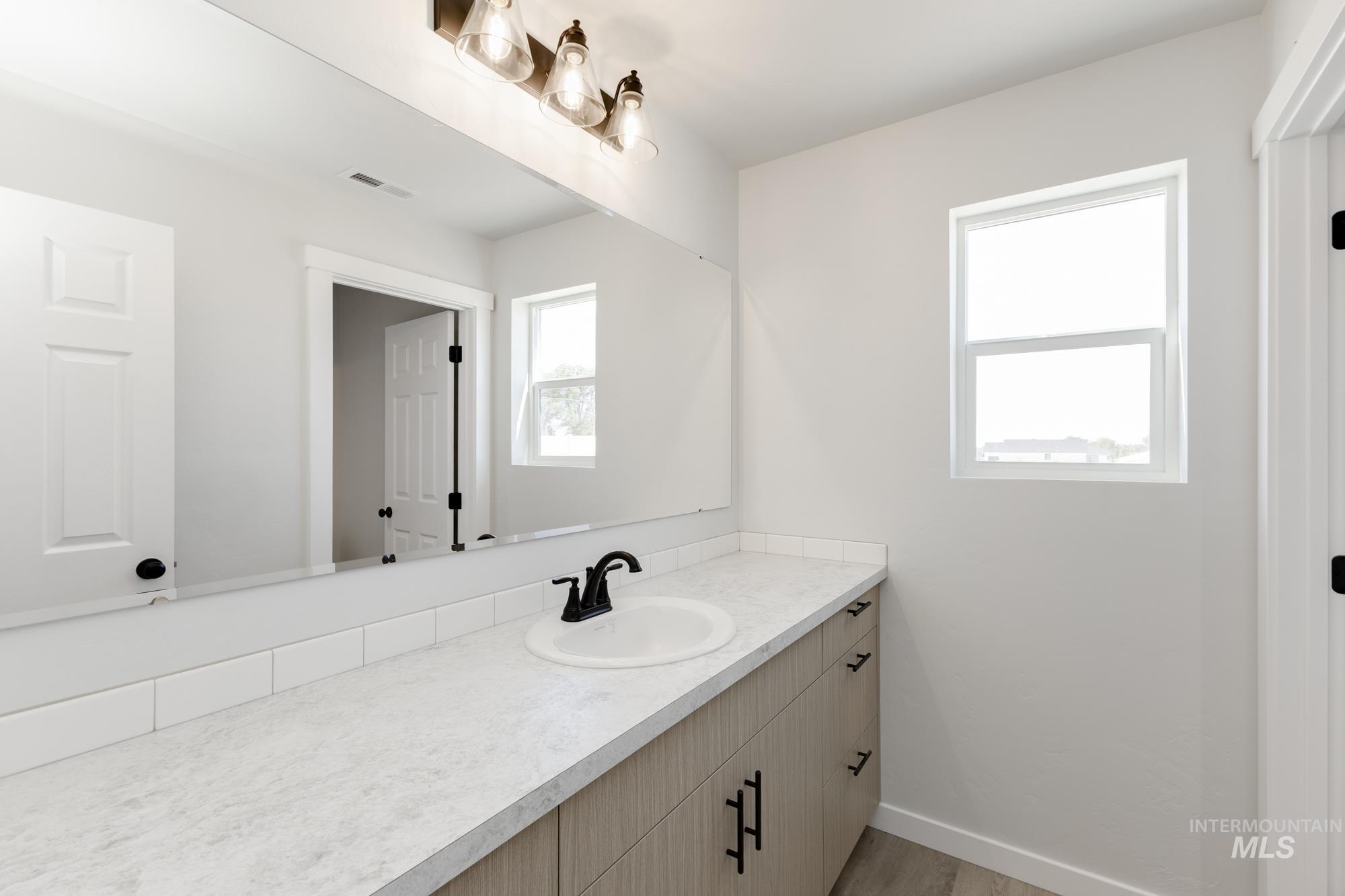 Bathroom with vanity and light wood-style floors