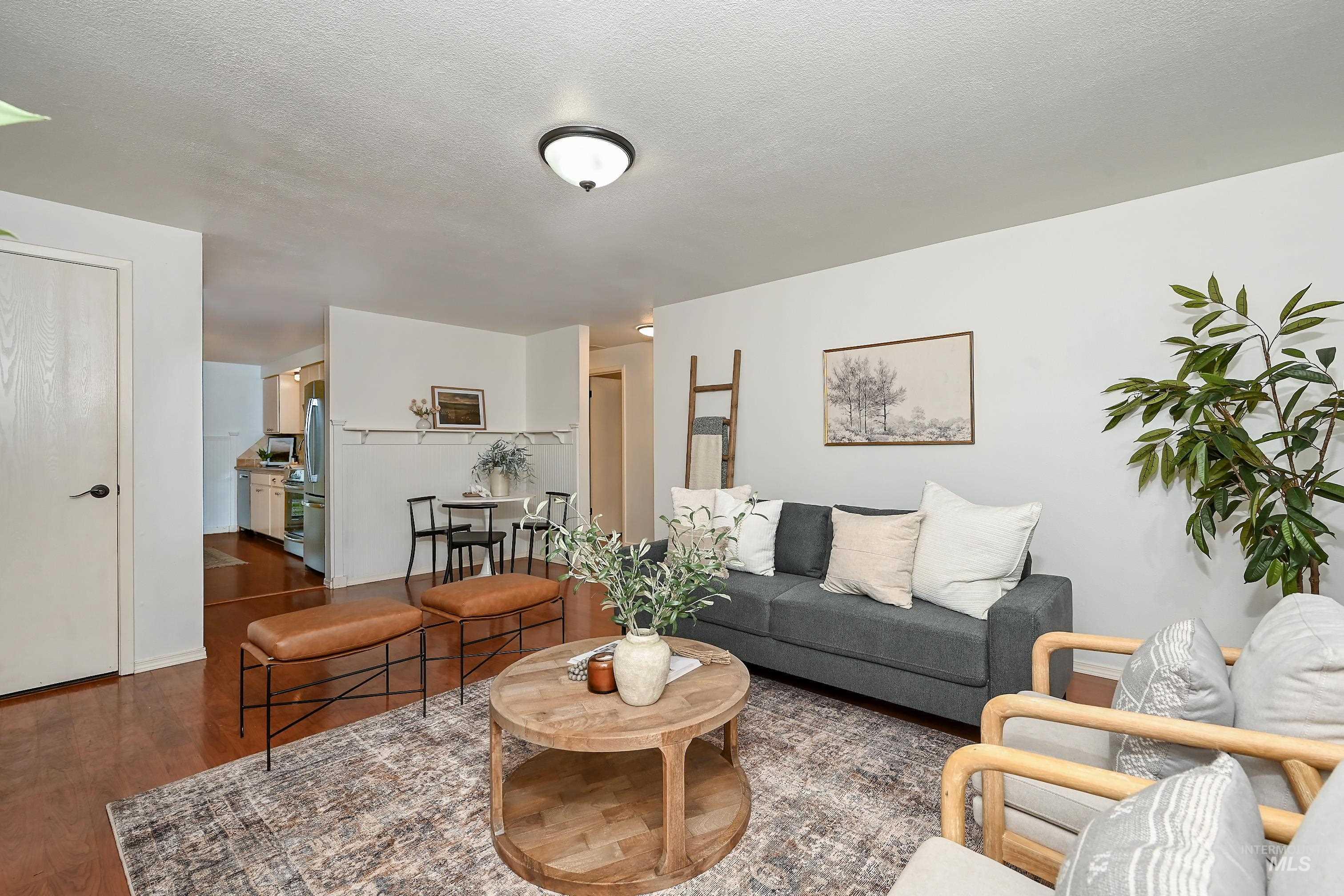 Living area featuring dark wood finished floors and a textured ceiling