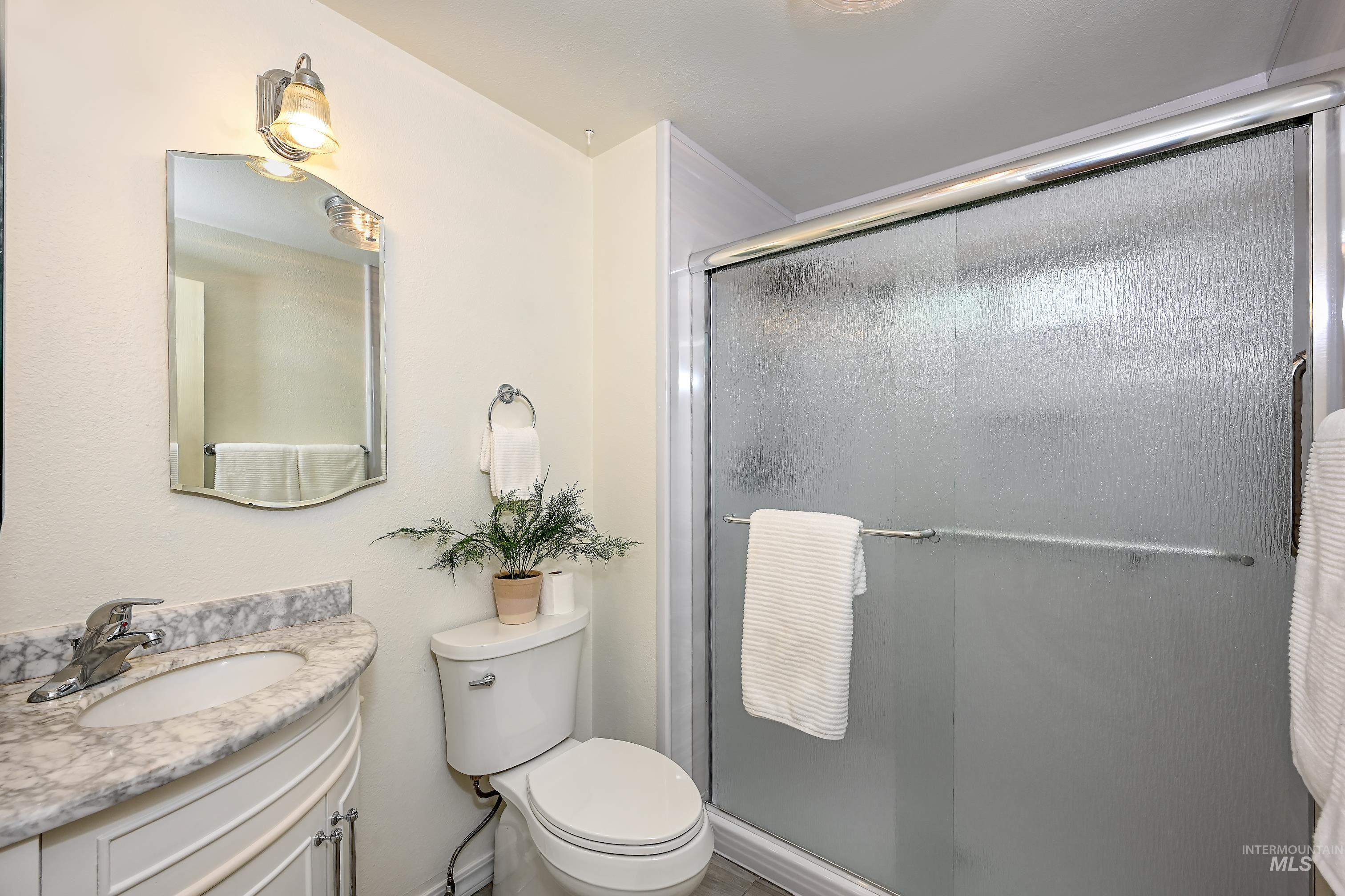 Bathroom featuring vanity and a shower stall