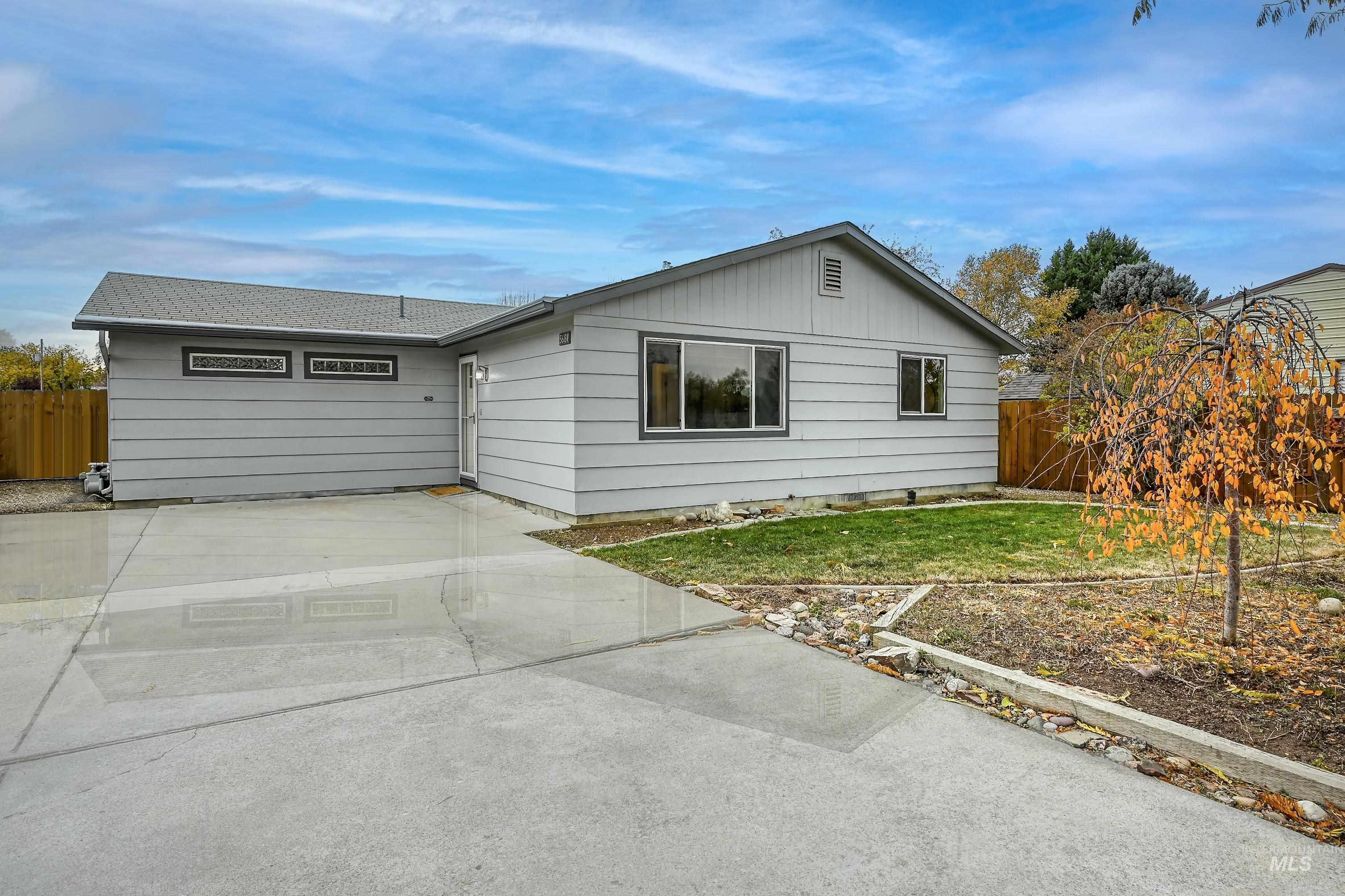 Ranch-style house with concrete driveway
