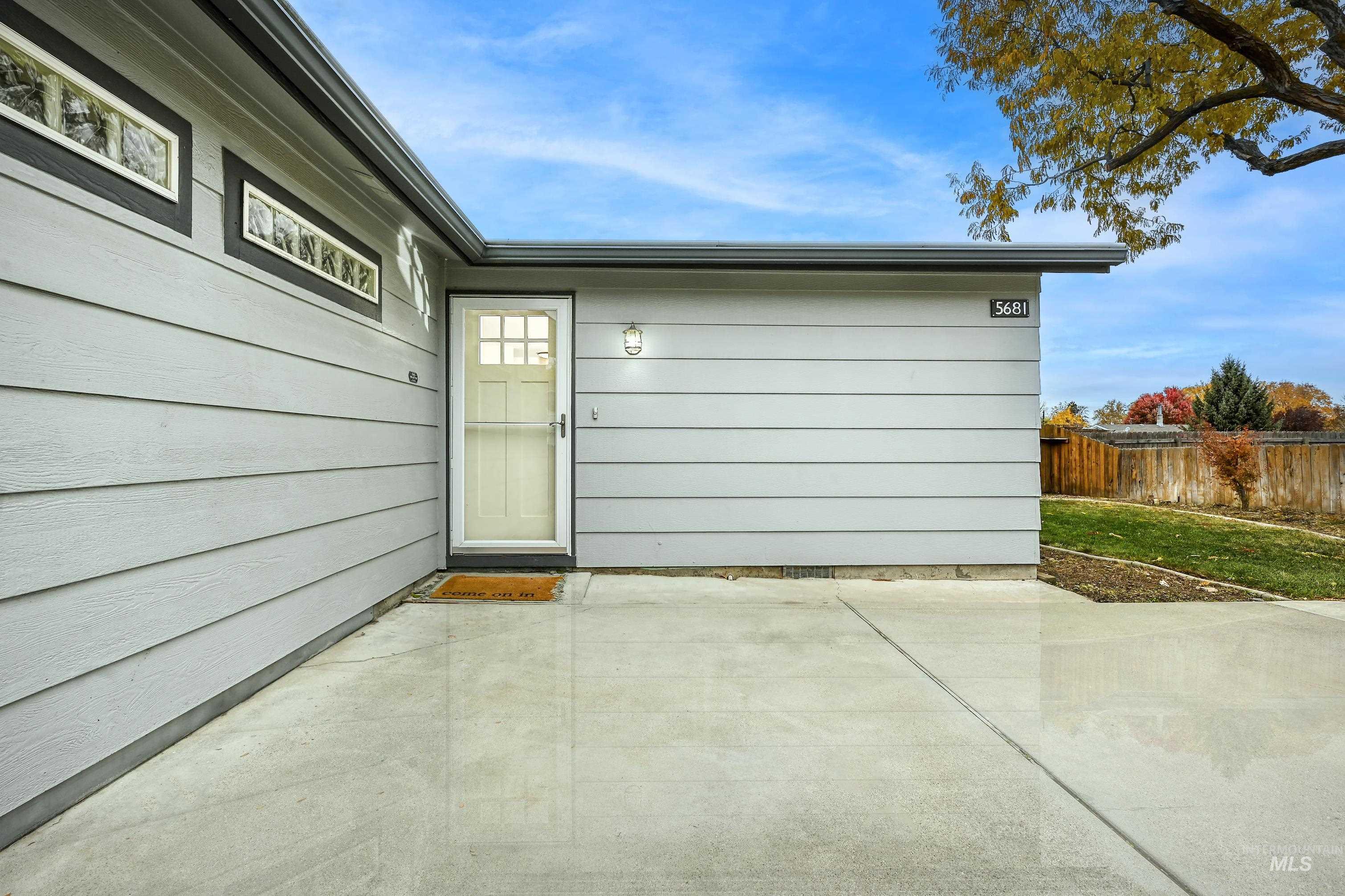 View of exterior entry featuring a patio