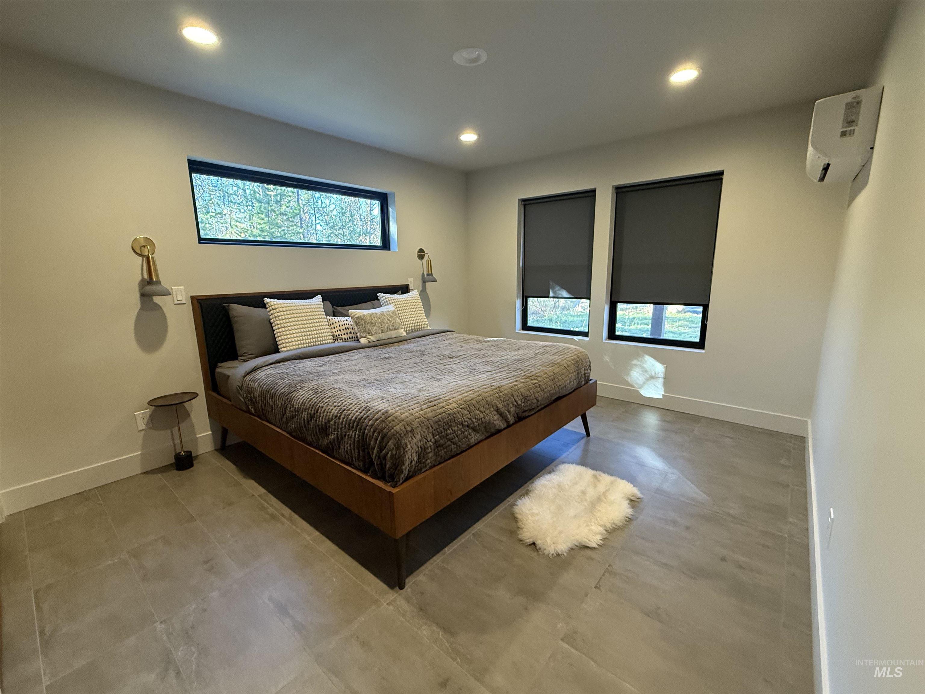 Bedroom with recessed lighting and a wall mounted mini split
