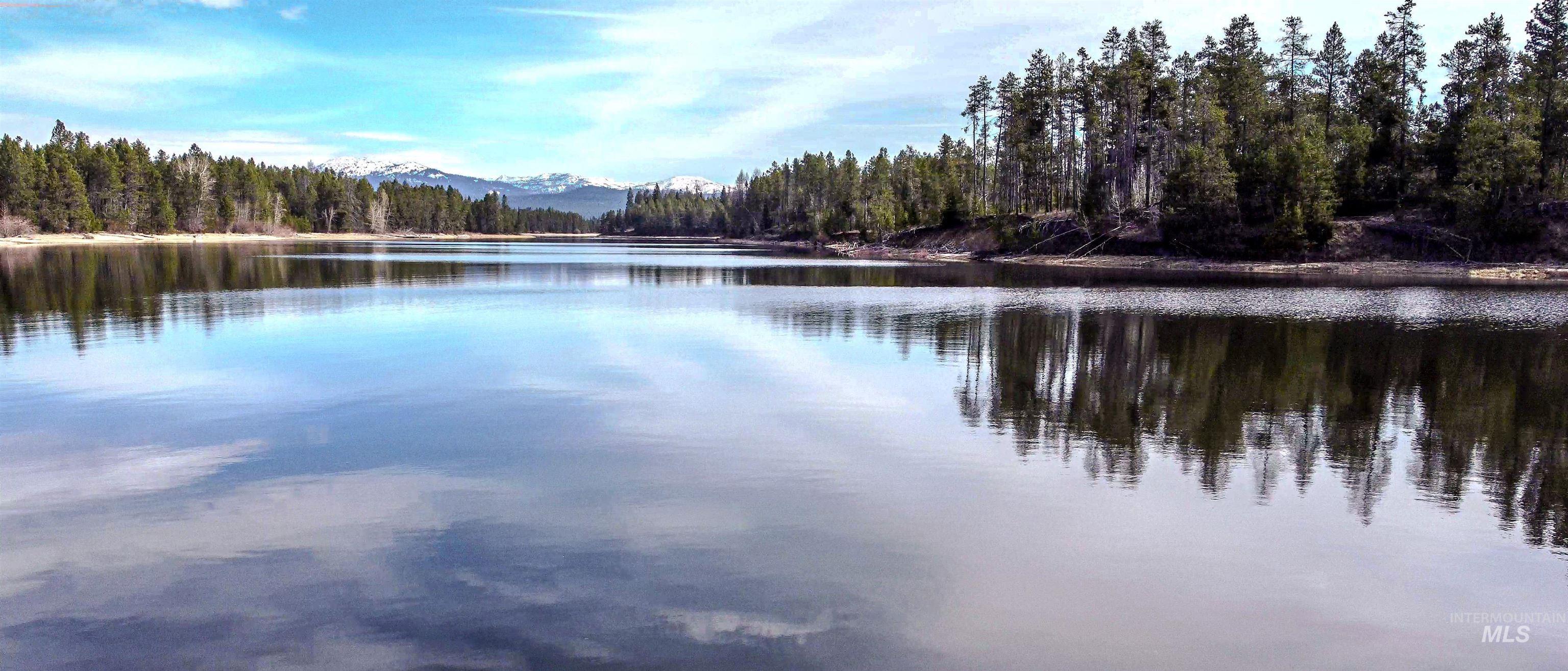 Water view with a heavily wooded area