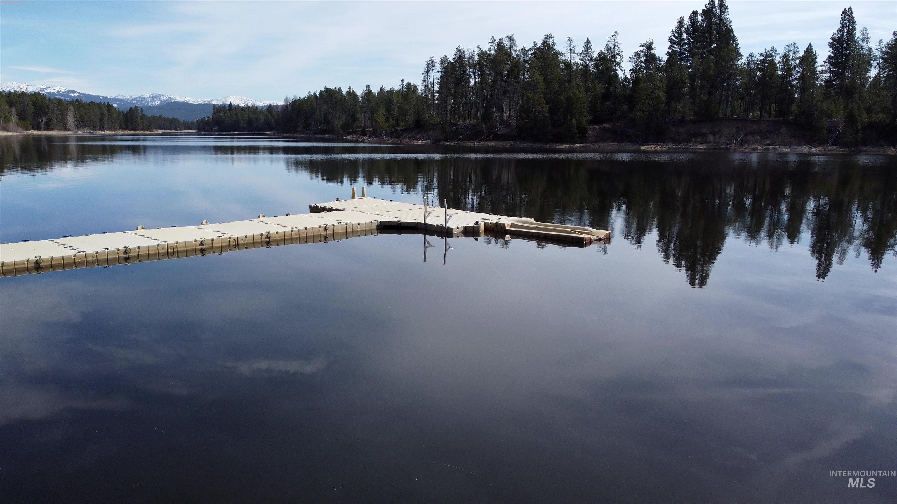 Dock area featuring a water view and a forest view
