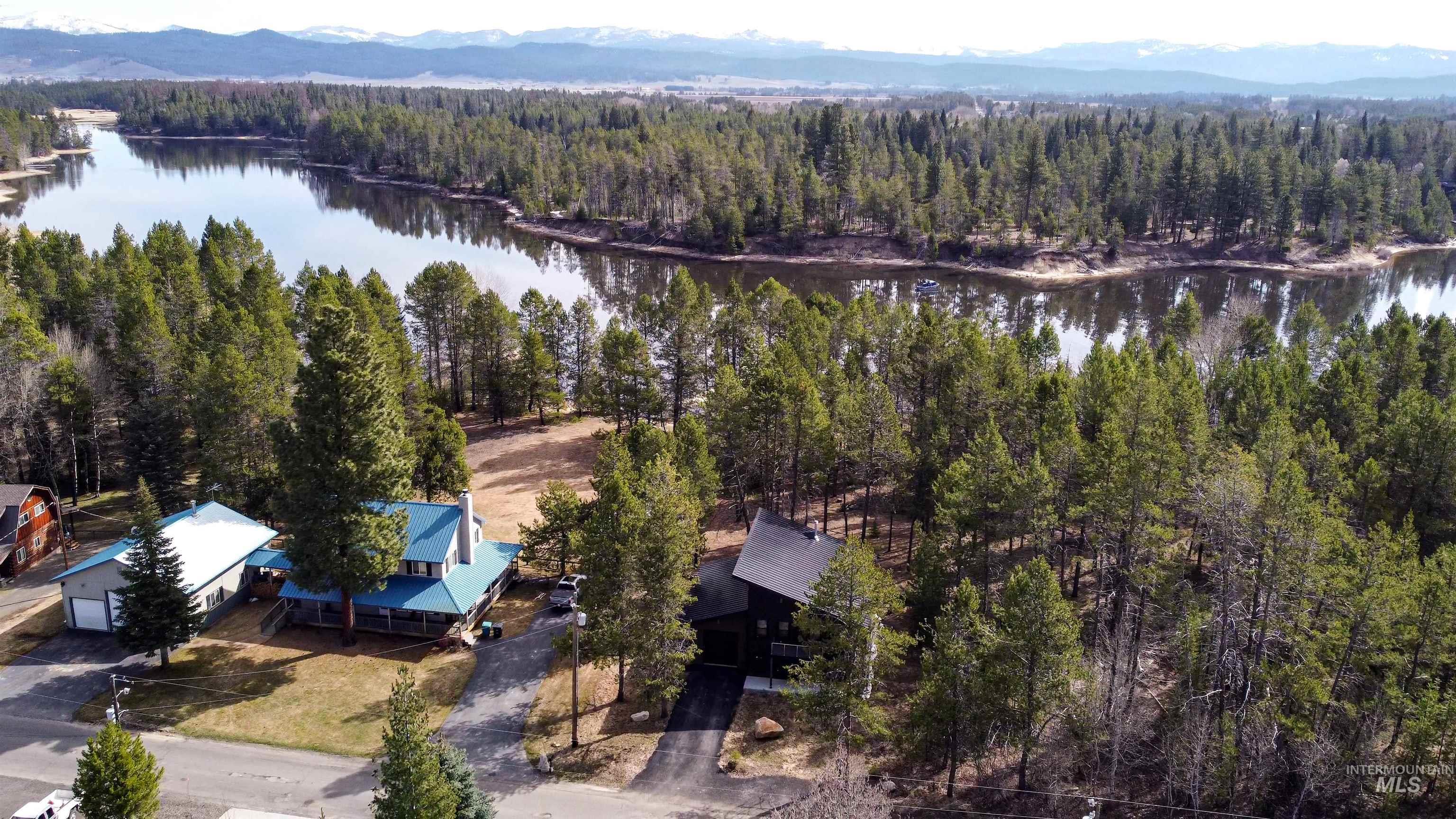 Bird's eye view of a water and mountain view and a forest