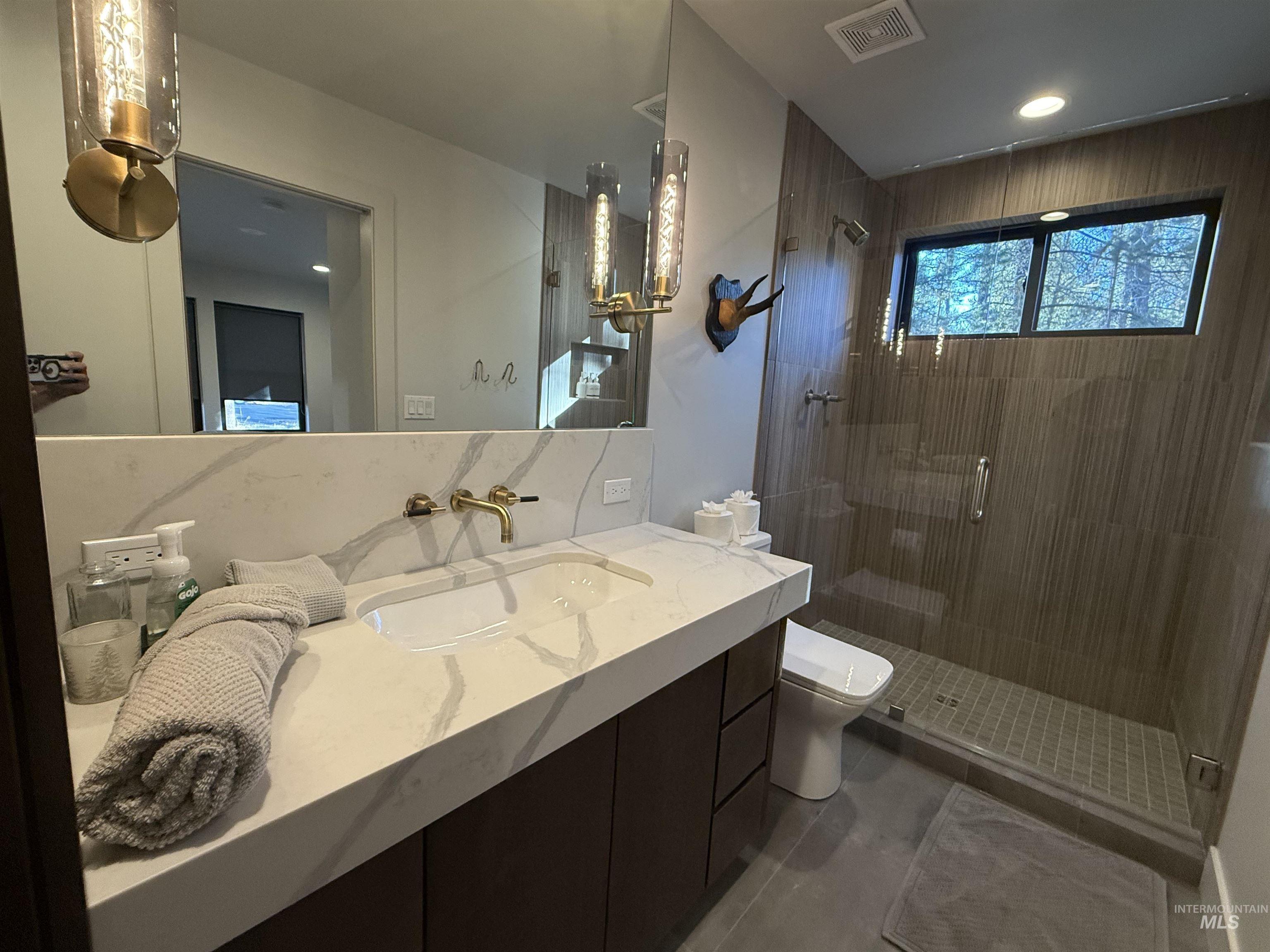 Full bathroom featuring vanity and a shower stall