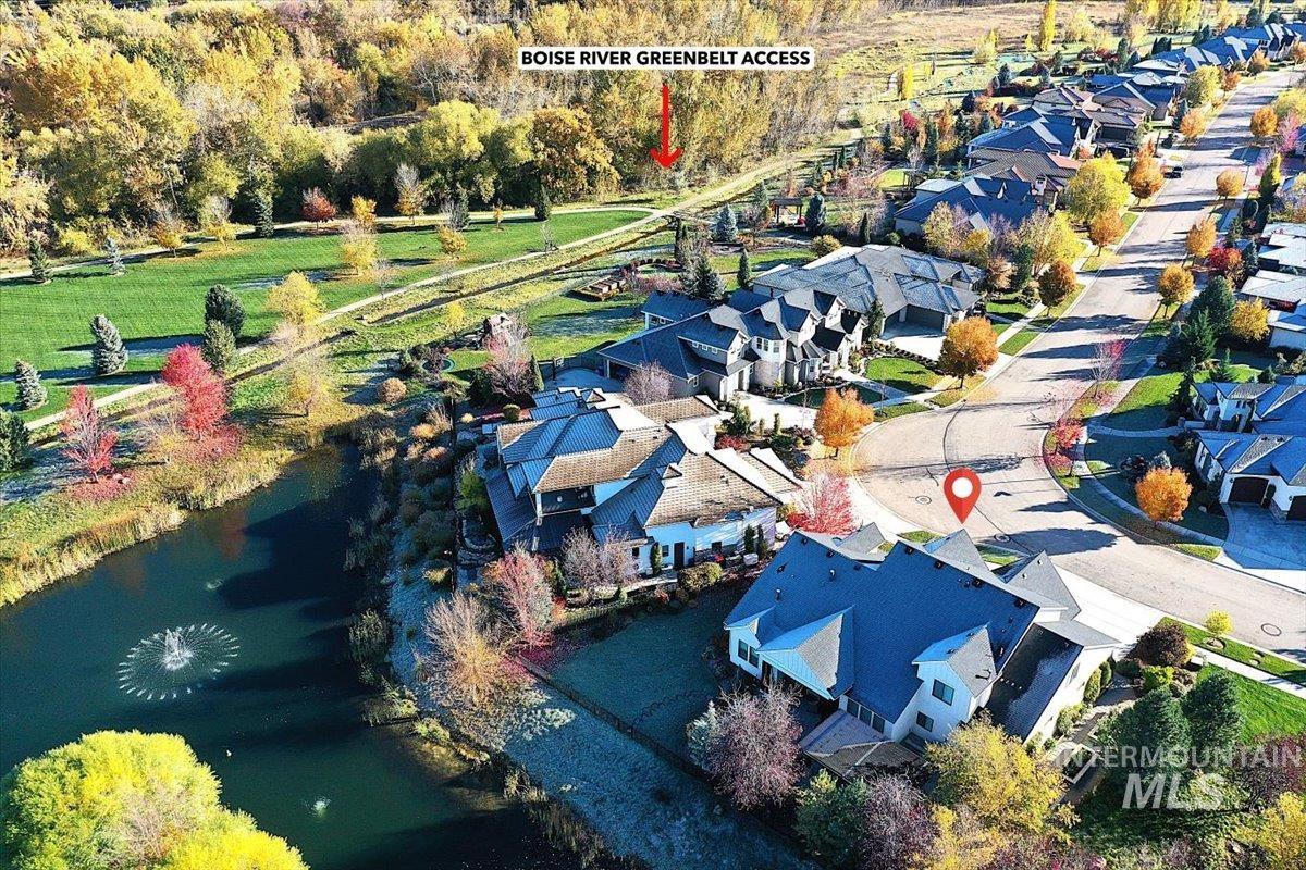 Aerial view of residential area featuring a nearby body of water