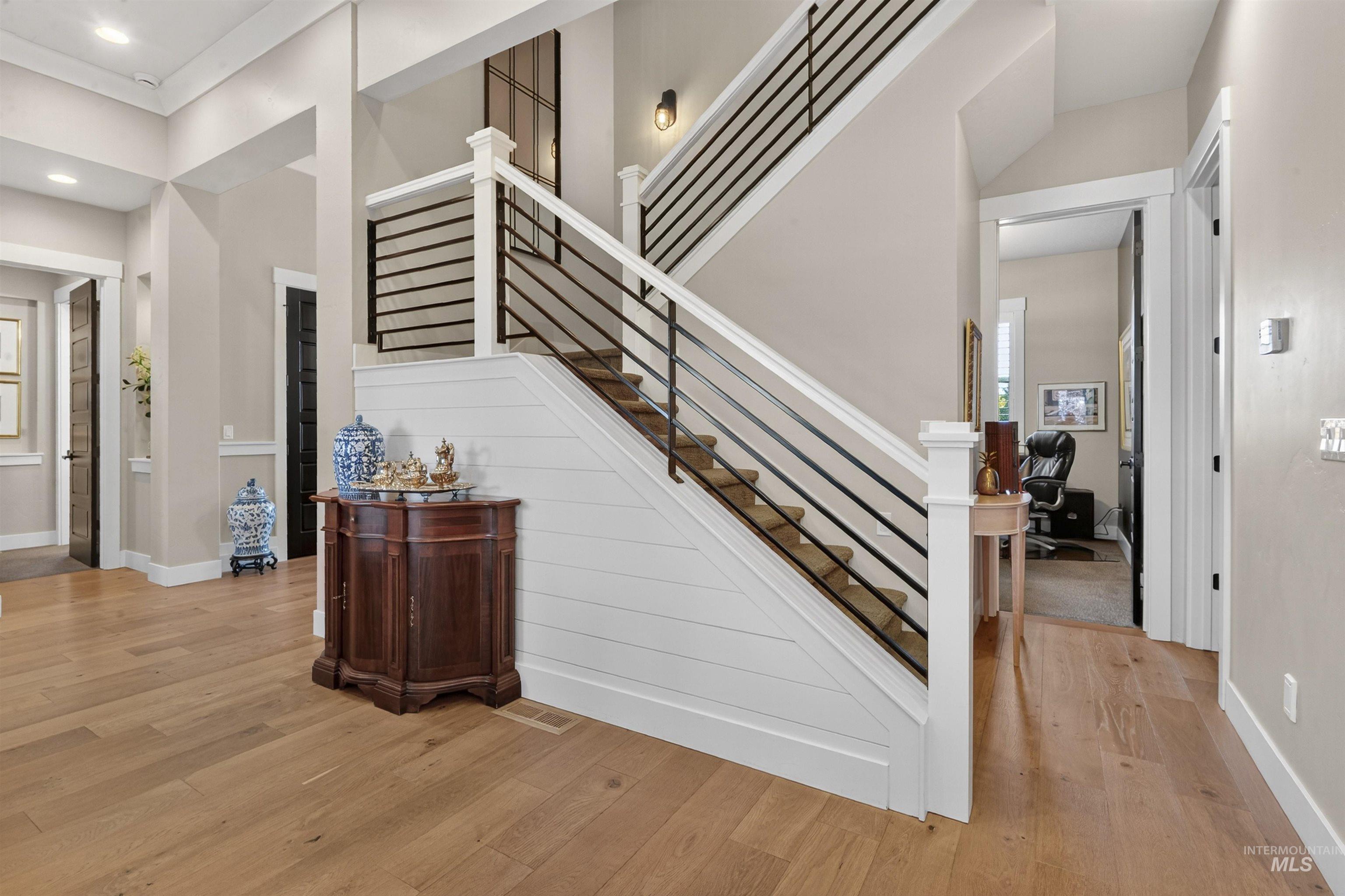 Stairs featuring hardwood / wood-style flooring