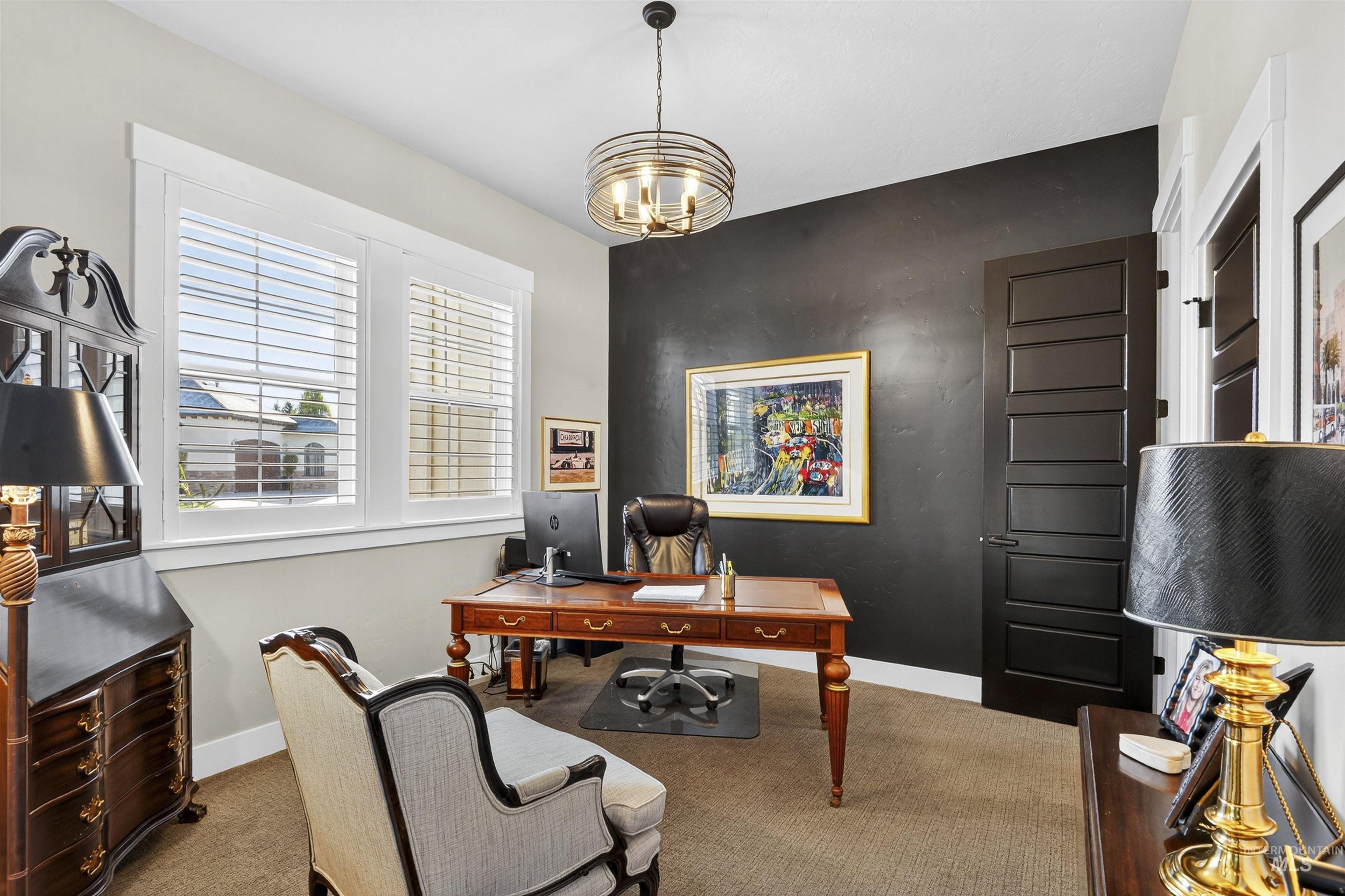 Office space featuring carpet and an accent wall