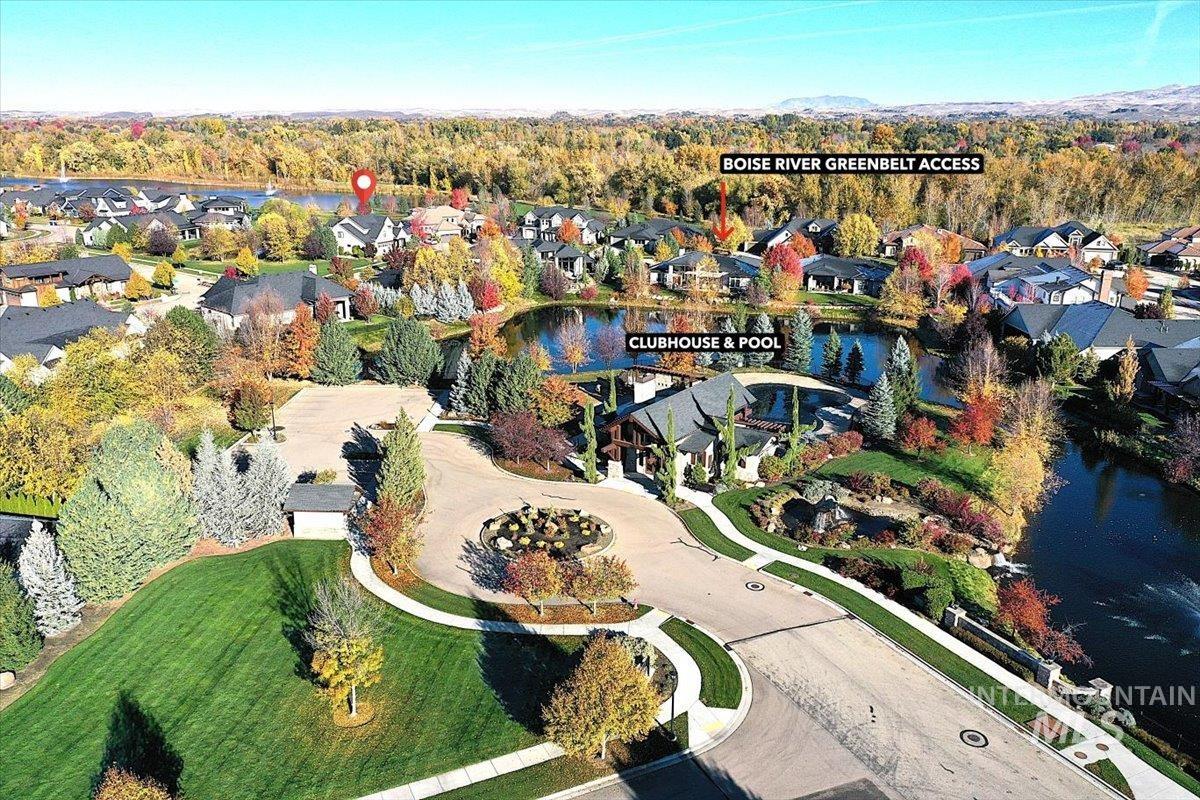 Aerial view of property and surrounding area featuring nearby suburban area and a large body of water