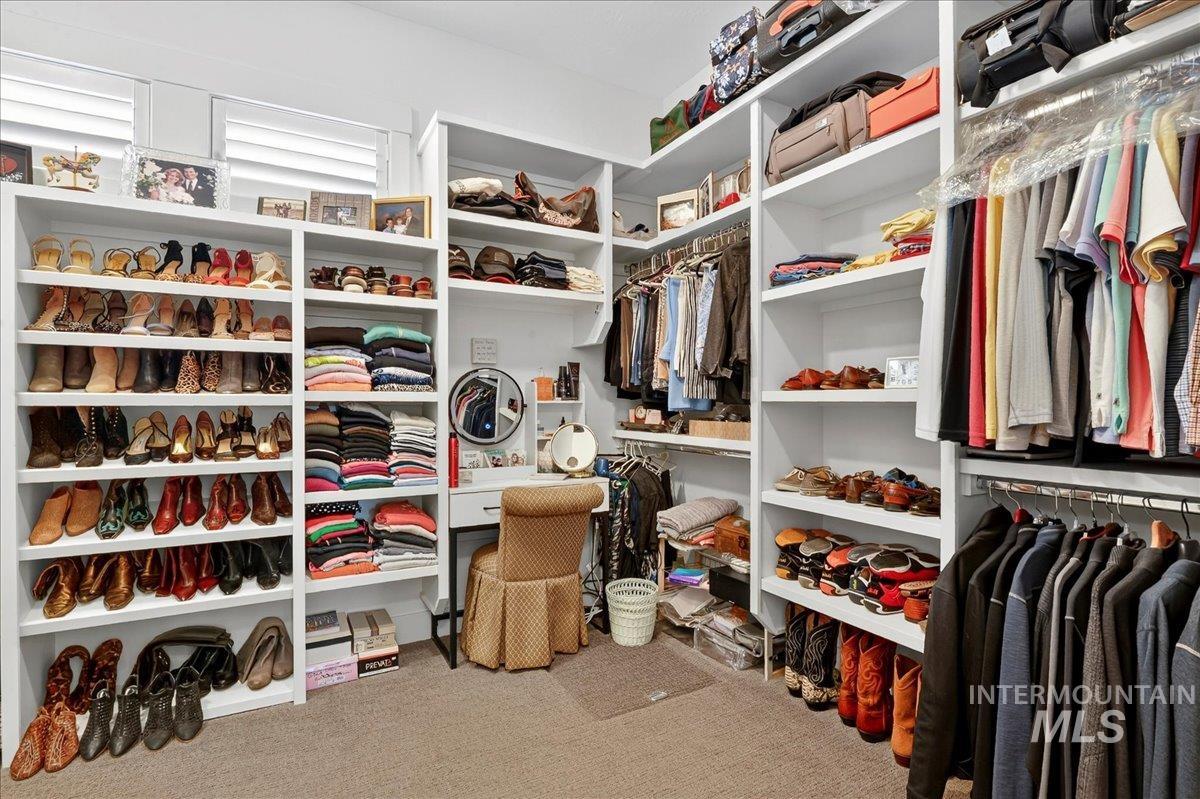 Spacious closet with light carpet