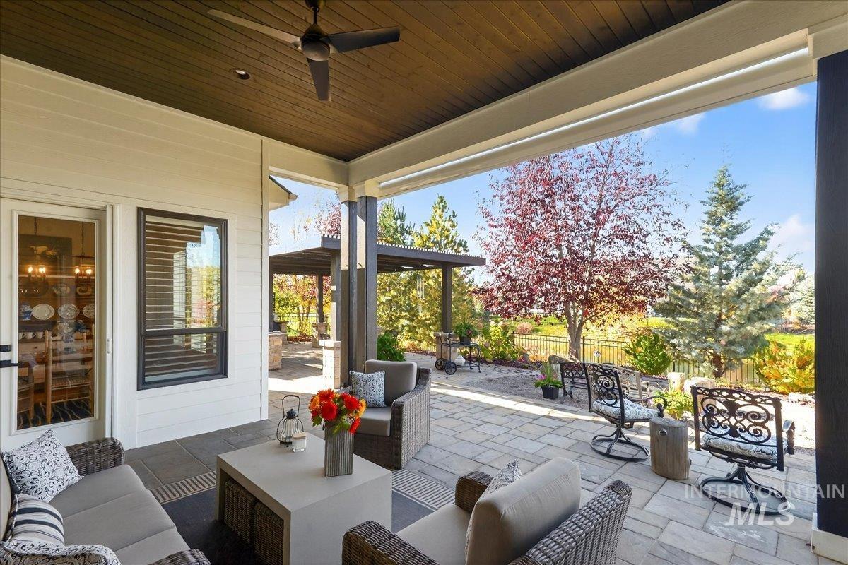 View of patio featuring an outdoor living space and ceiling fan