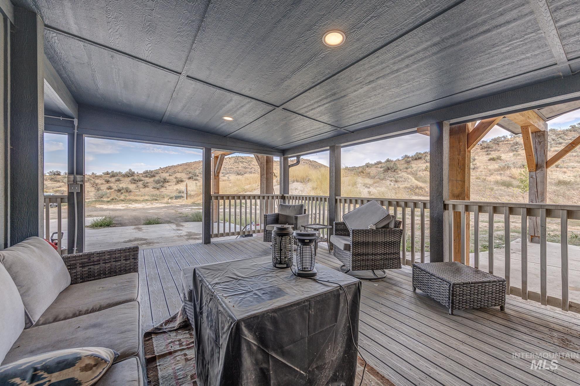 Wooden deck featuring a mountain view and an outdoor hangout area