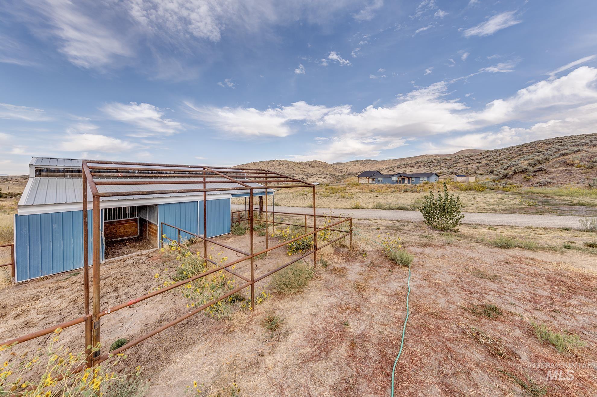 View of yard with an exterior structure, an outbuilding, and a mountain view