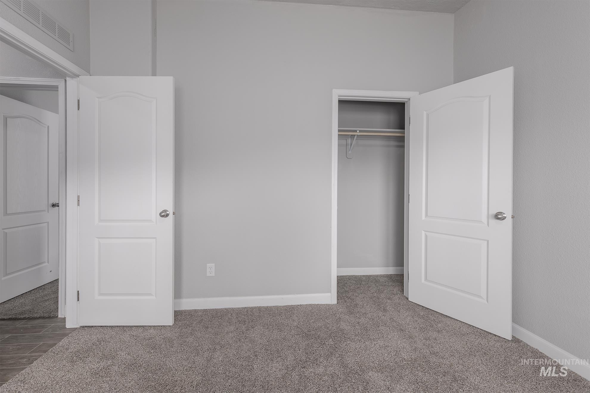 Unfurnished bedroom featuring carpet floors and a closet