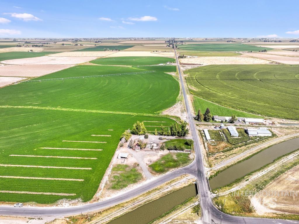Aerial view of property and surrounding area with farmland and rural landscape