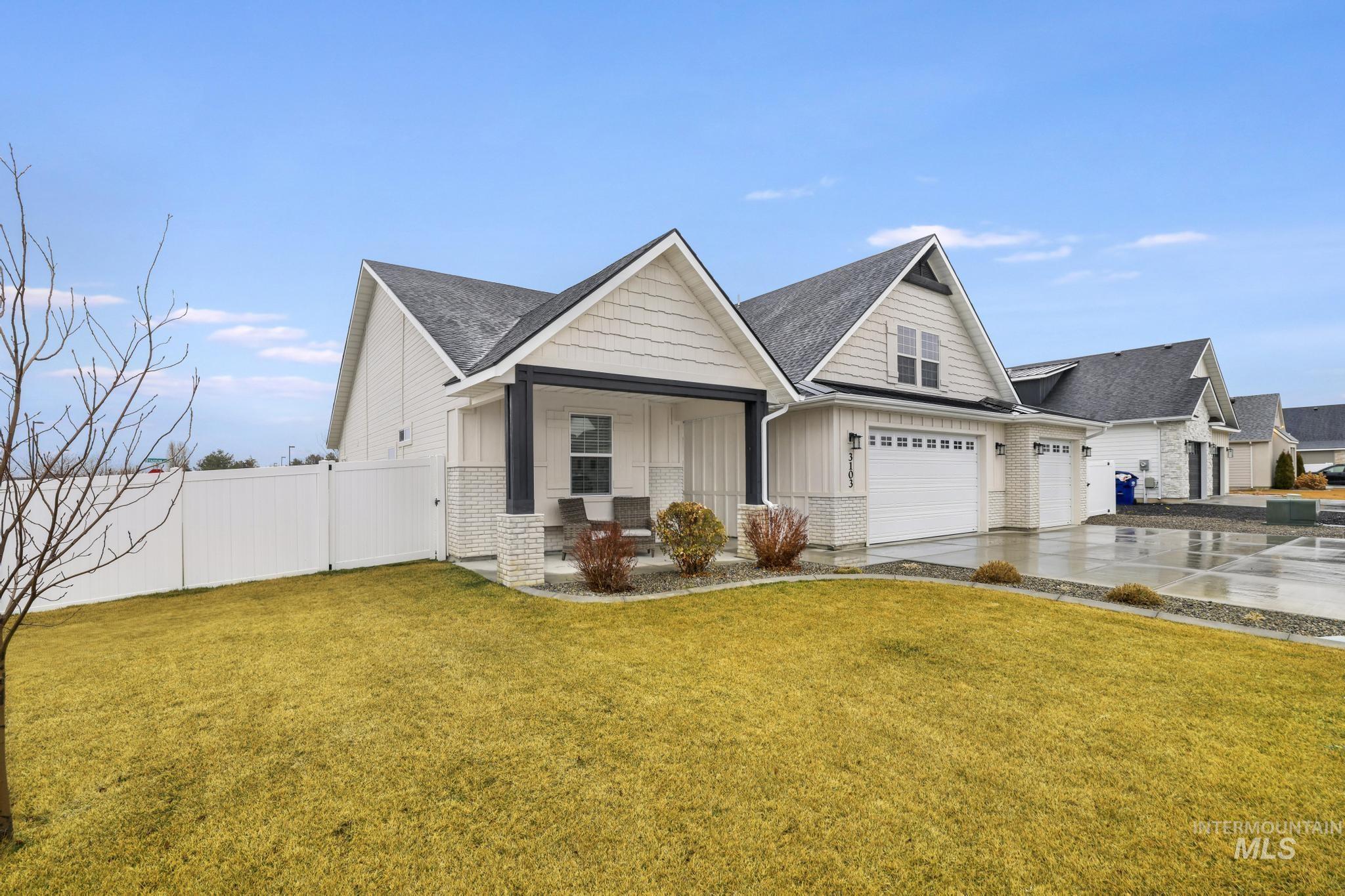 View of front of property with concrete driveway, board and batten siding, roof with shingles, and covered porch