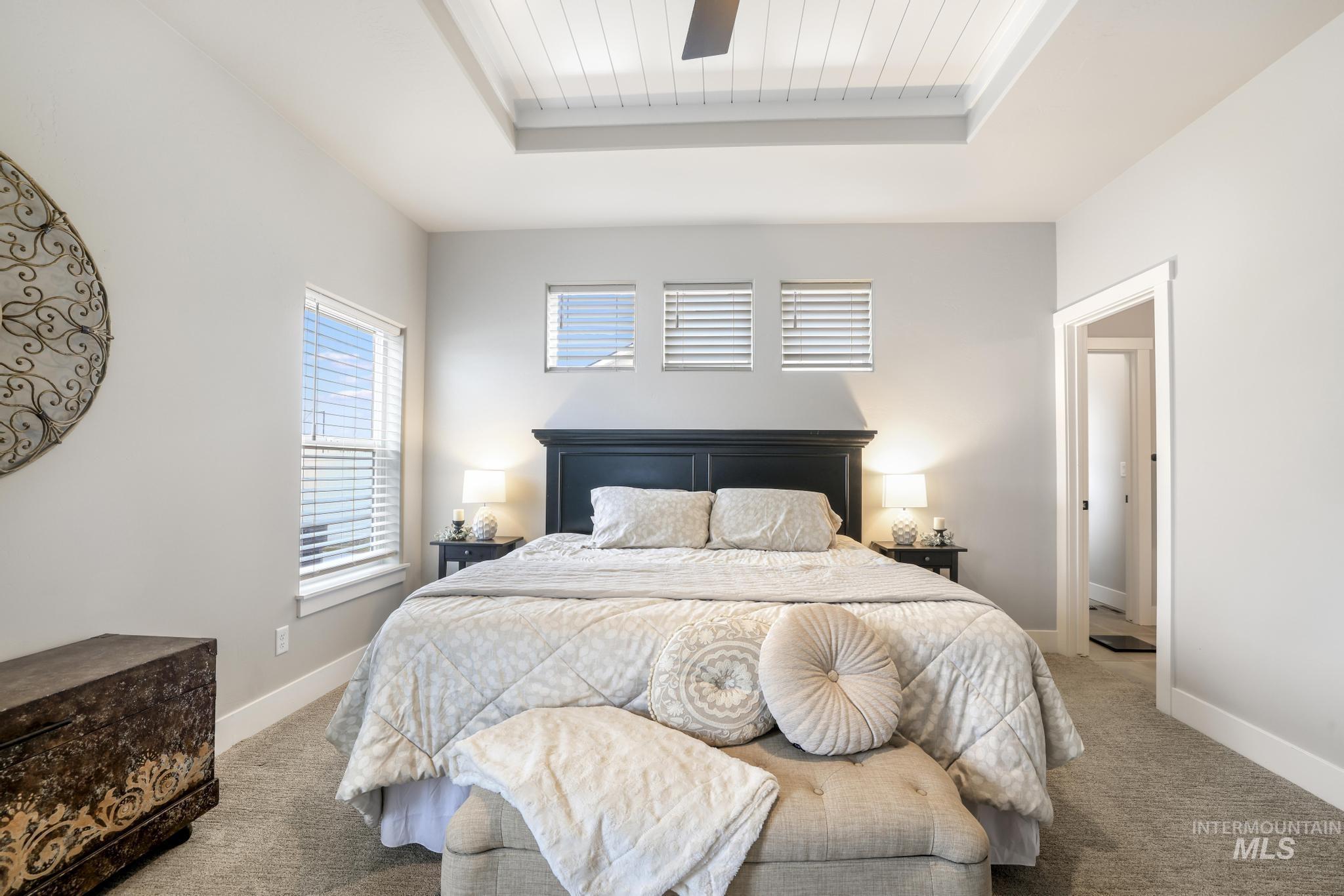 Bedroom with carpet and a tray ceiling