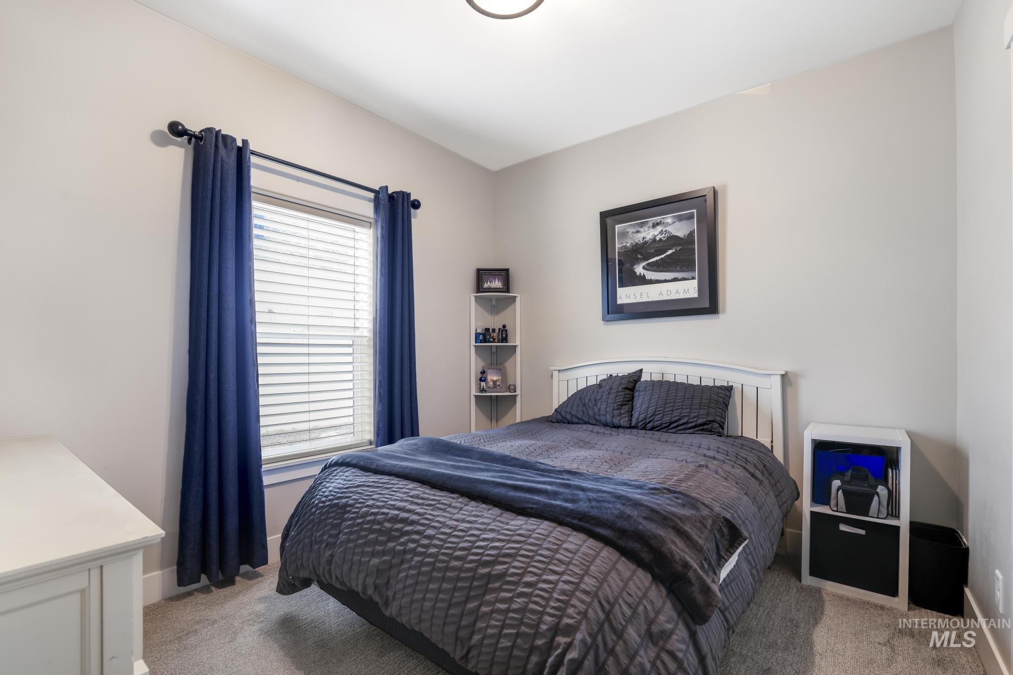 Bedroom with light carpet and baseboards