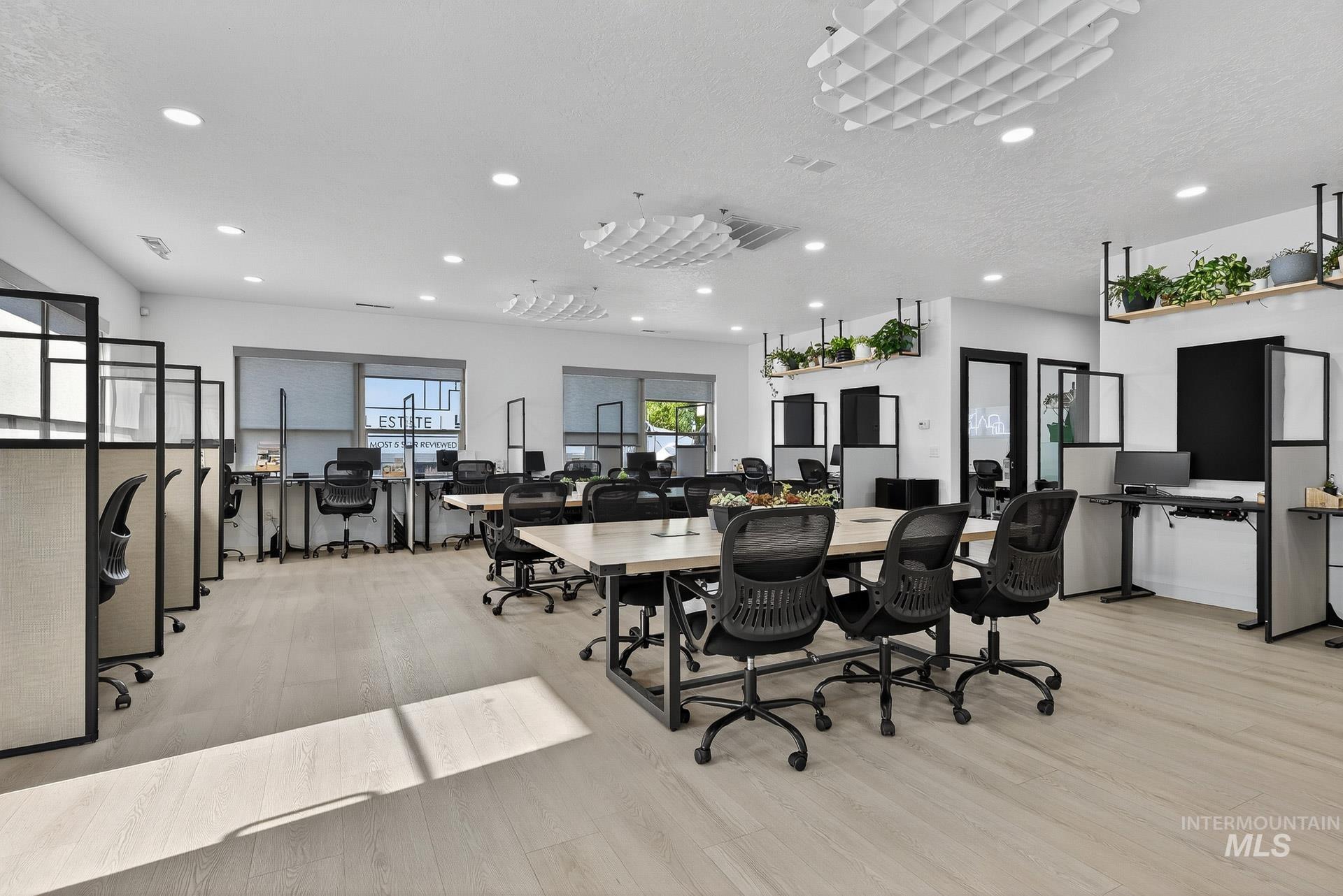 Dining space featuring an office area, light wood-type flooring, recessed lighting, and a textured ceiling