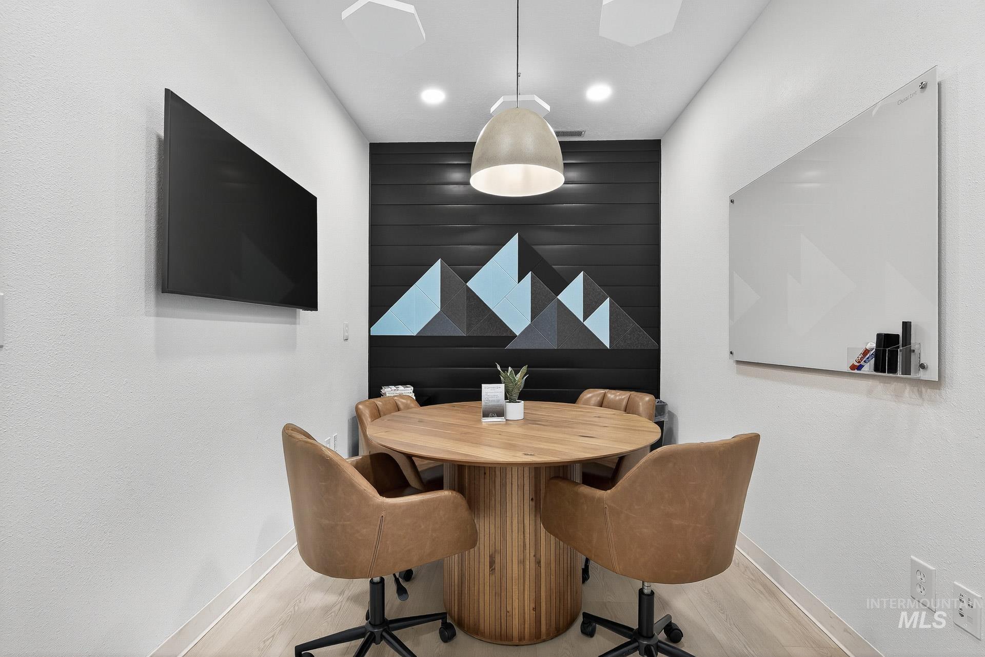 Dining area with wood finished floors and recessed lighting