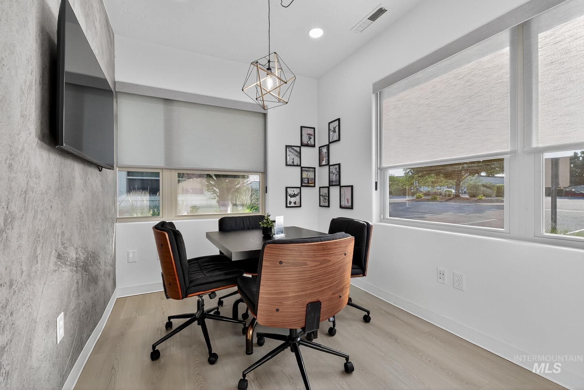 Office with healthy amount of natural light, recessed lighting, and light wood-type flooring