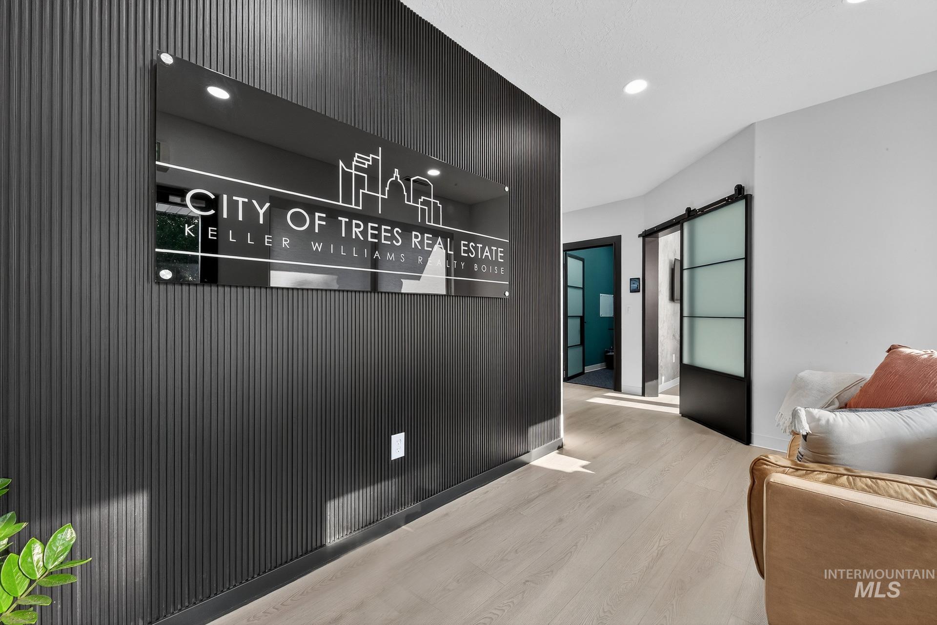 Reception area featuring a barn door and recessed lighting