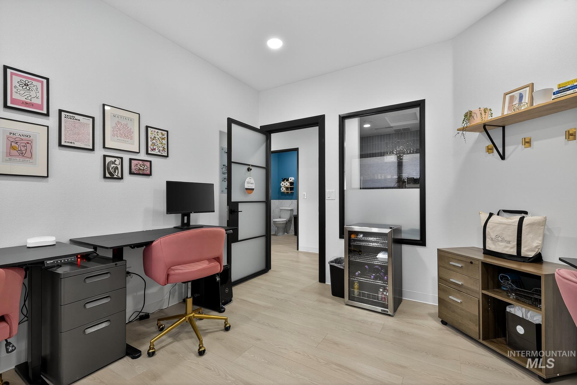 Office featuring light wood-type flooring, wine cooler, and recessed lighting