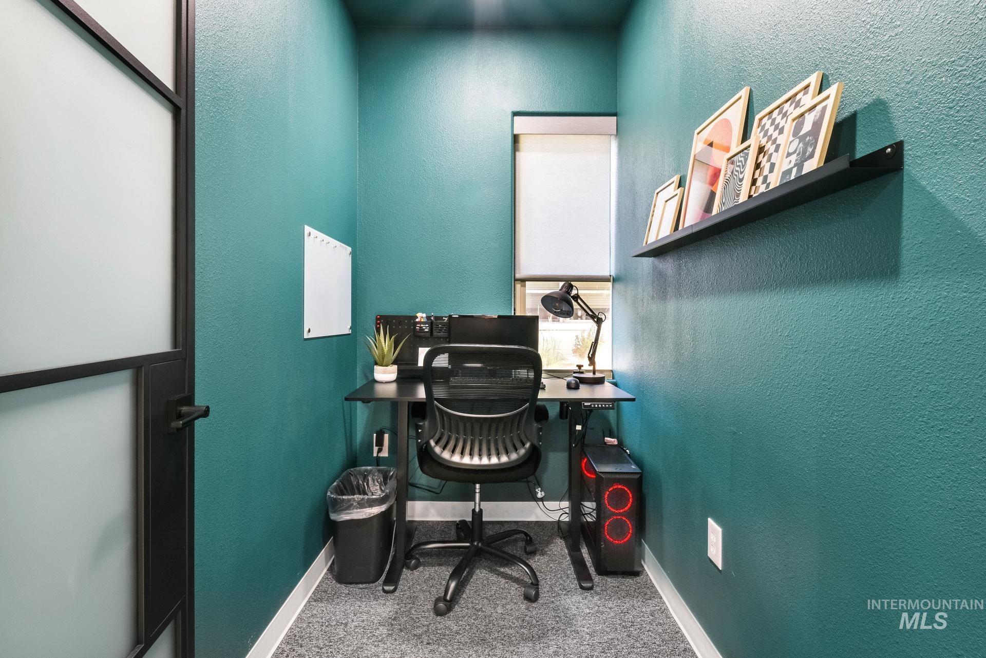 Office space with a textured wall and carpet