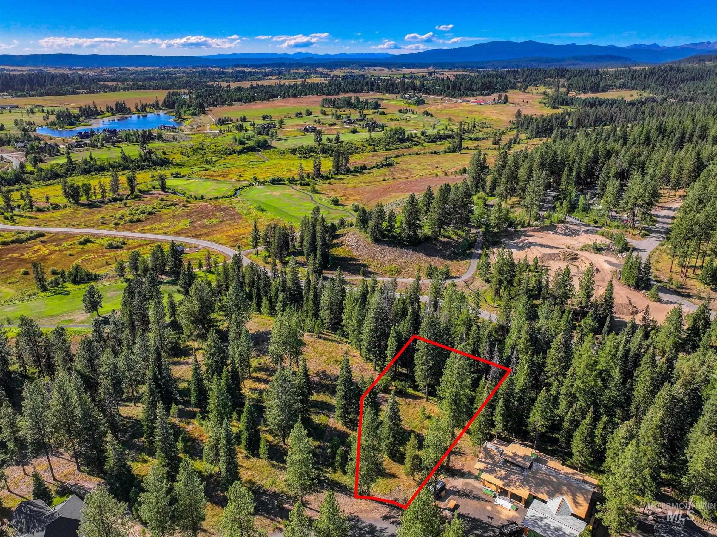 Aerial view of property's location with property boundaries highlighted and a water and mountain view
