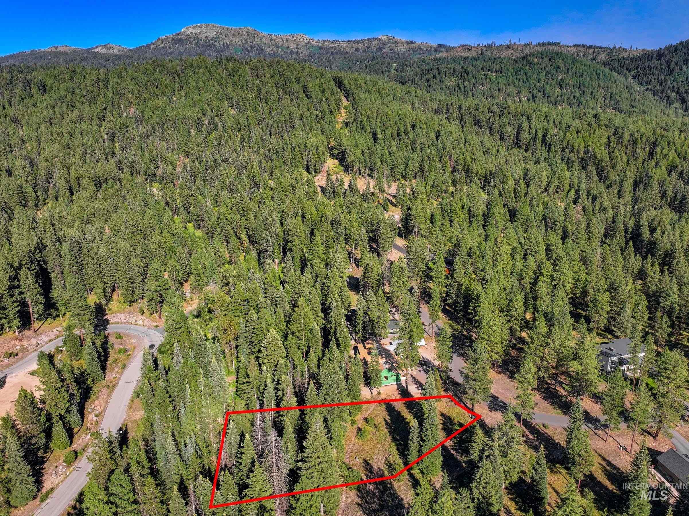 Aerial overview of property's location featuring mountains and property parcel outlined
