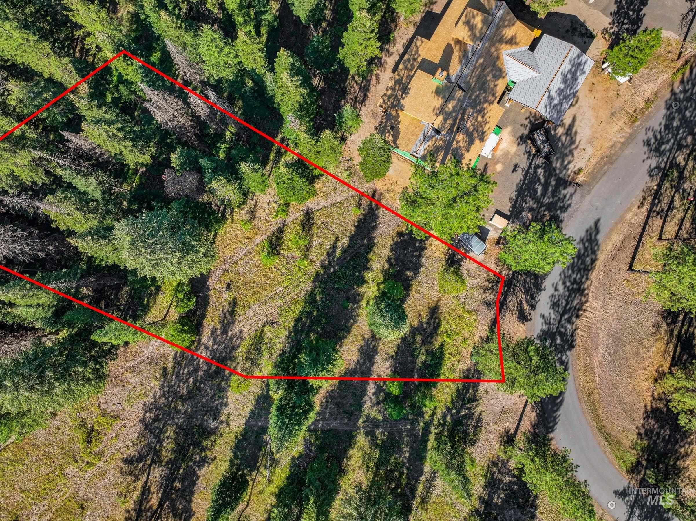 Aerial view of property and surrounding area featuring property parcel outlined