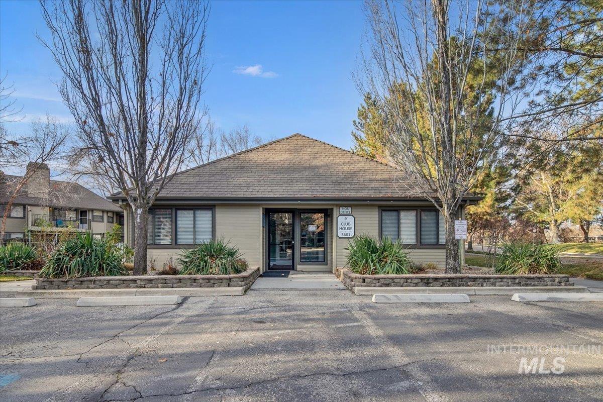 Ranch-style house with uncovered parking and a shingled roof