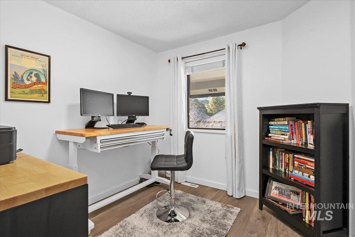 Office space featuring a textured ceiling and light wood finished floors