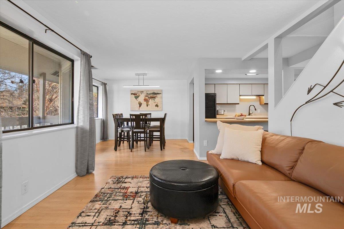 Living area with light wood-style floors and baseboards