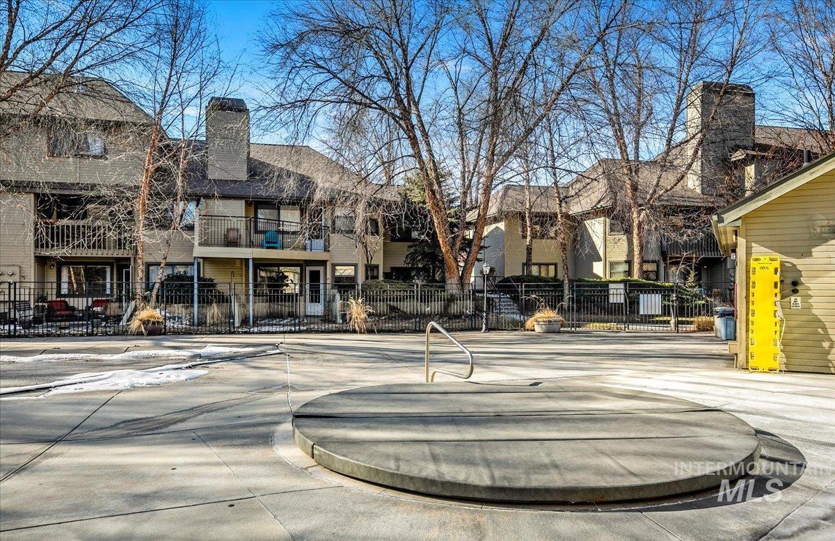 View of concrete road featuring curbs and a residential view