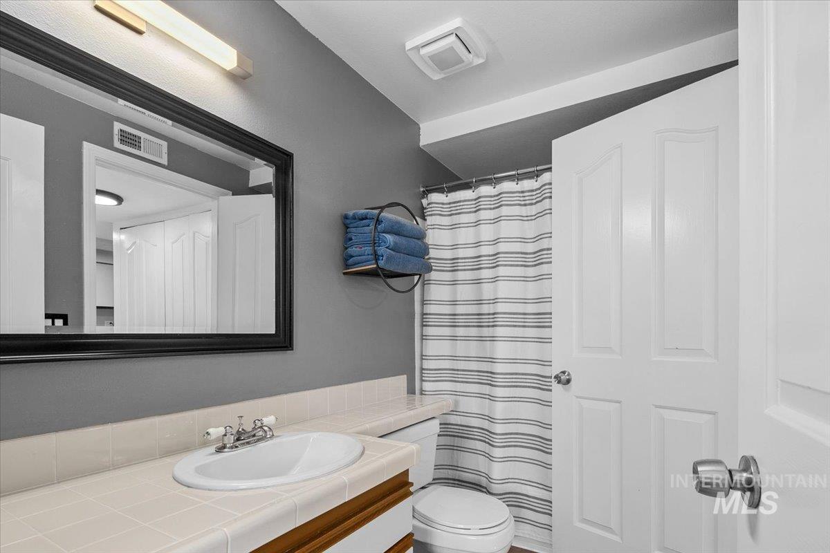 Bathroom featuring vanity and a shower with shower curtain