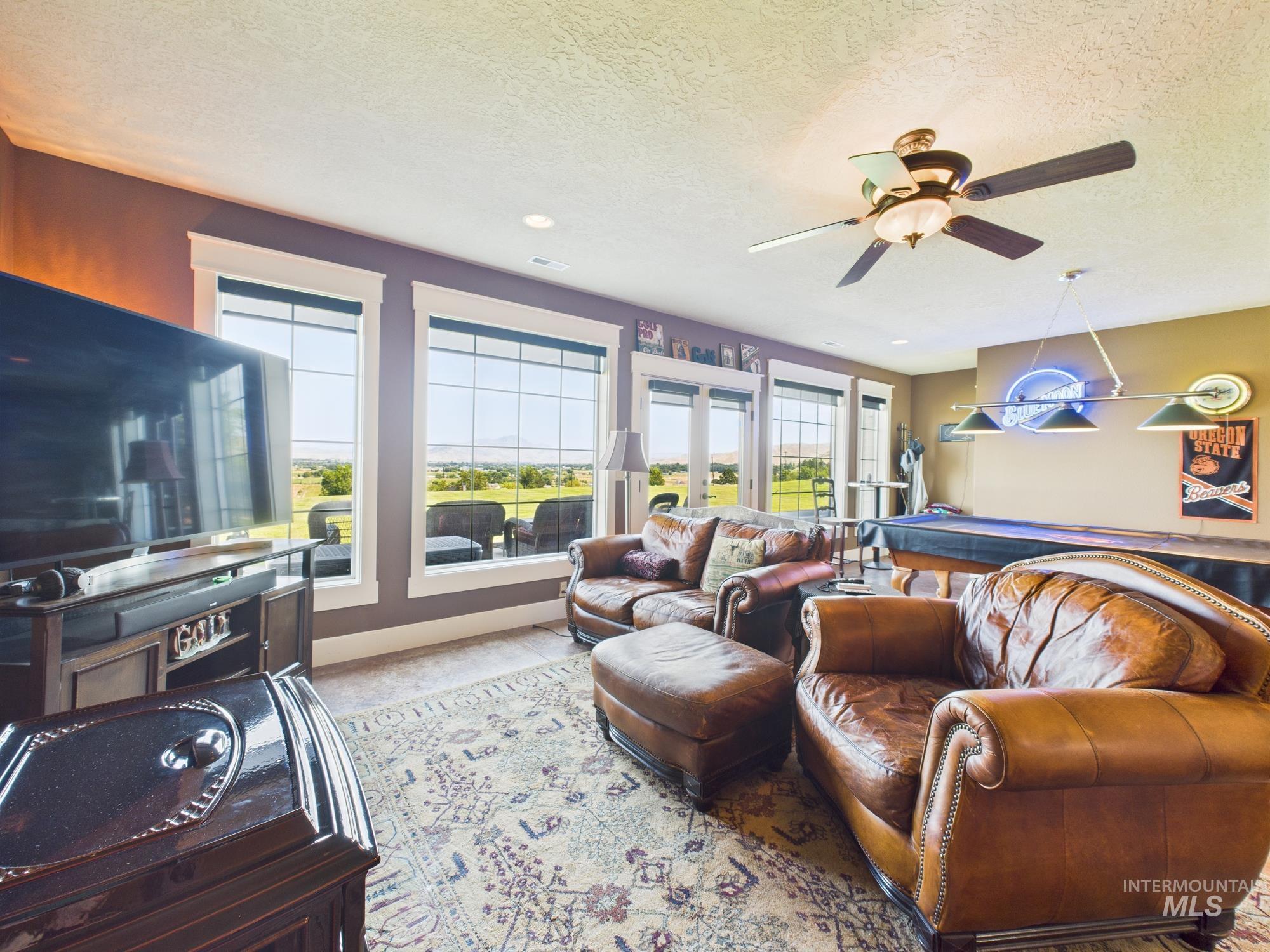 Living area featuring a textured ceiling and a ceiling fan