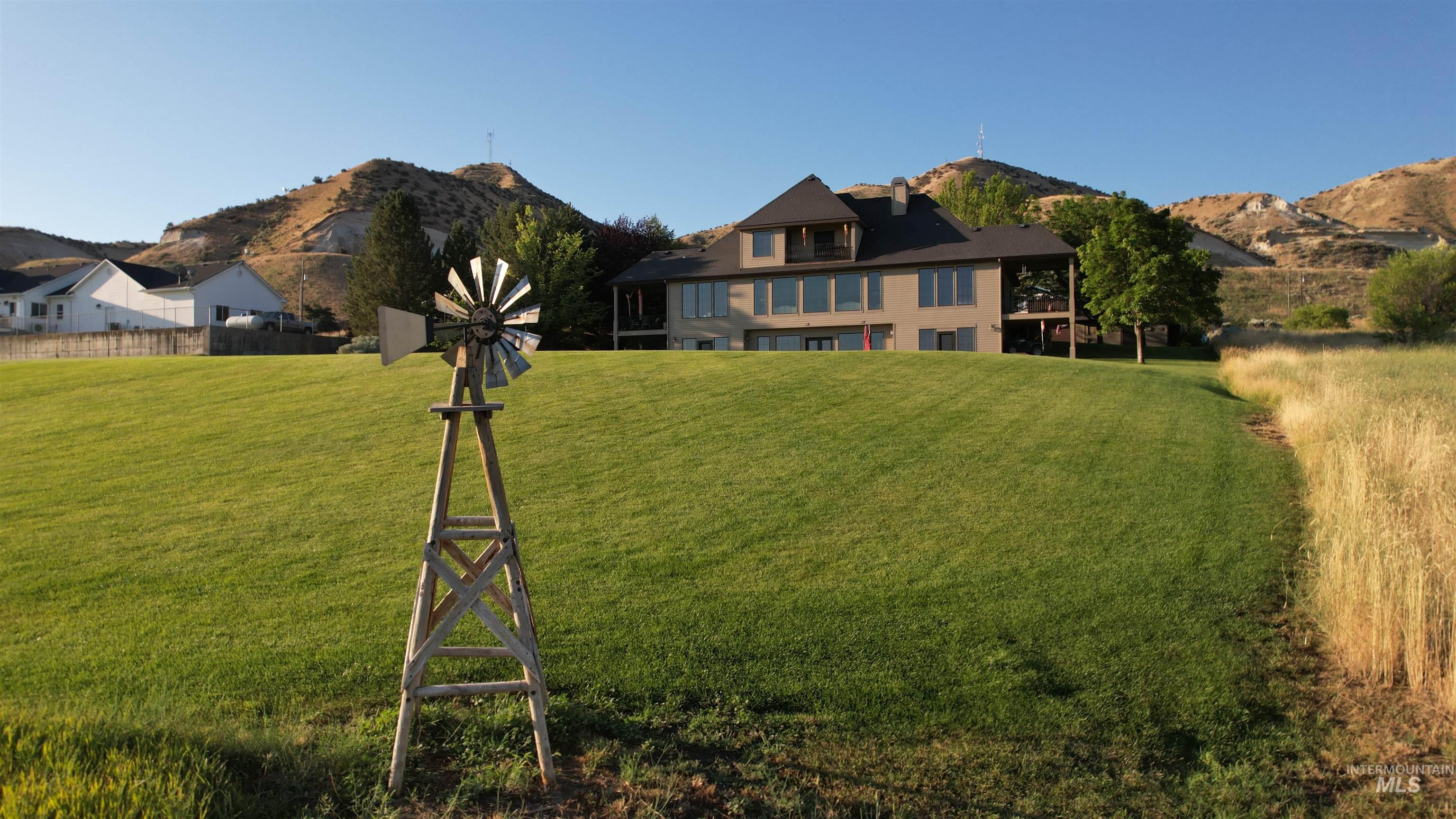 View of grassy yard featuring a mountain view