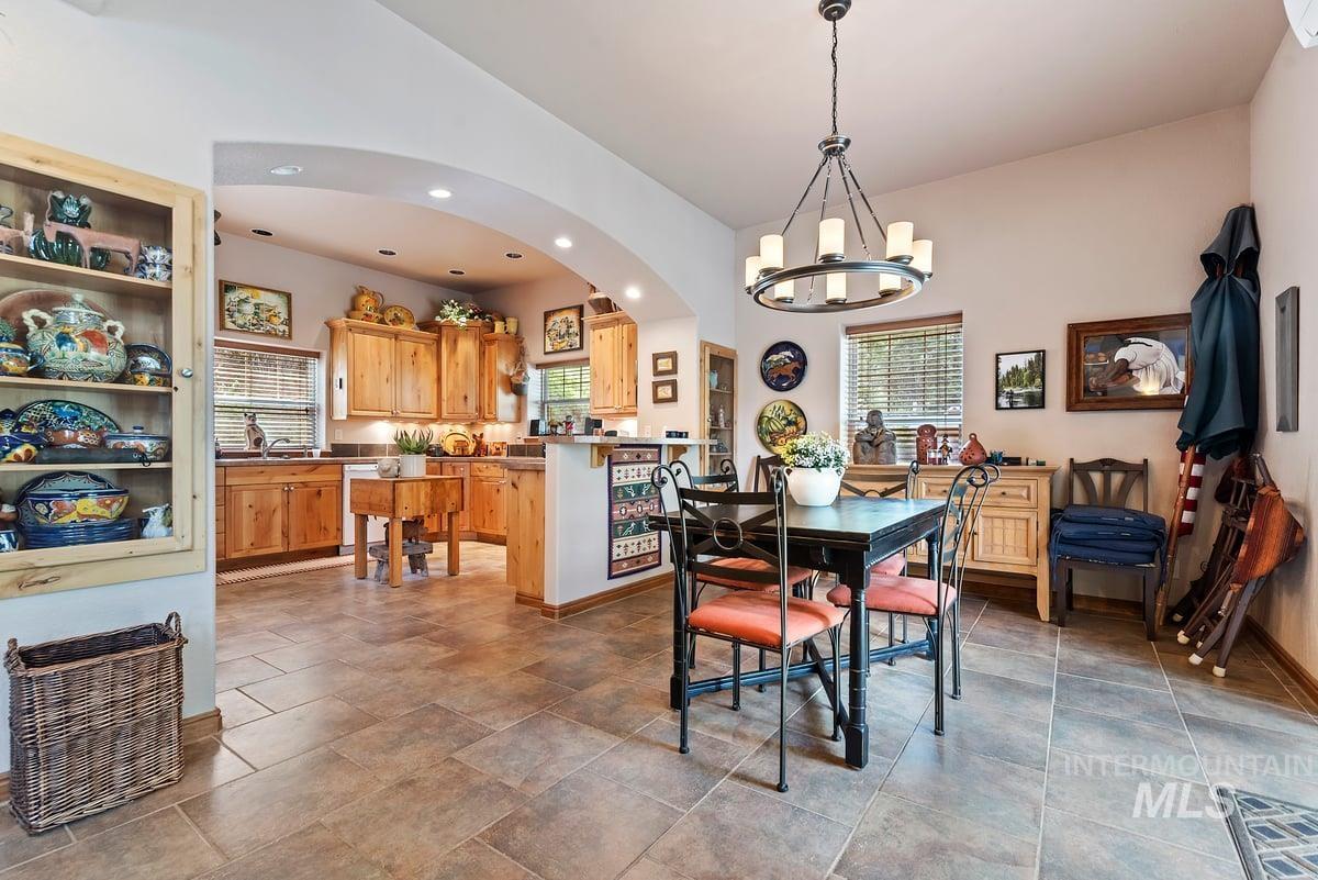 Dining space with recessed lighting and a chandelier