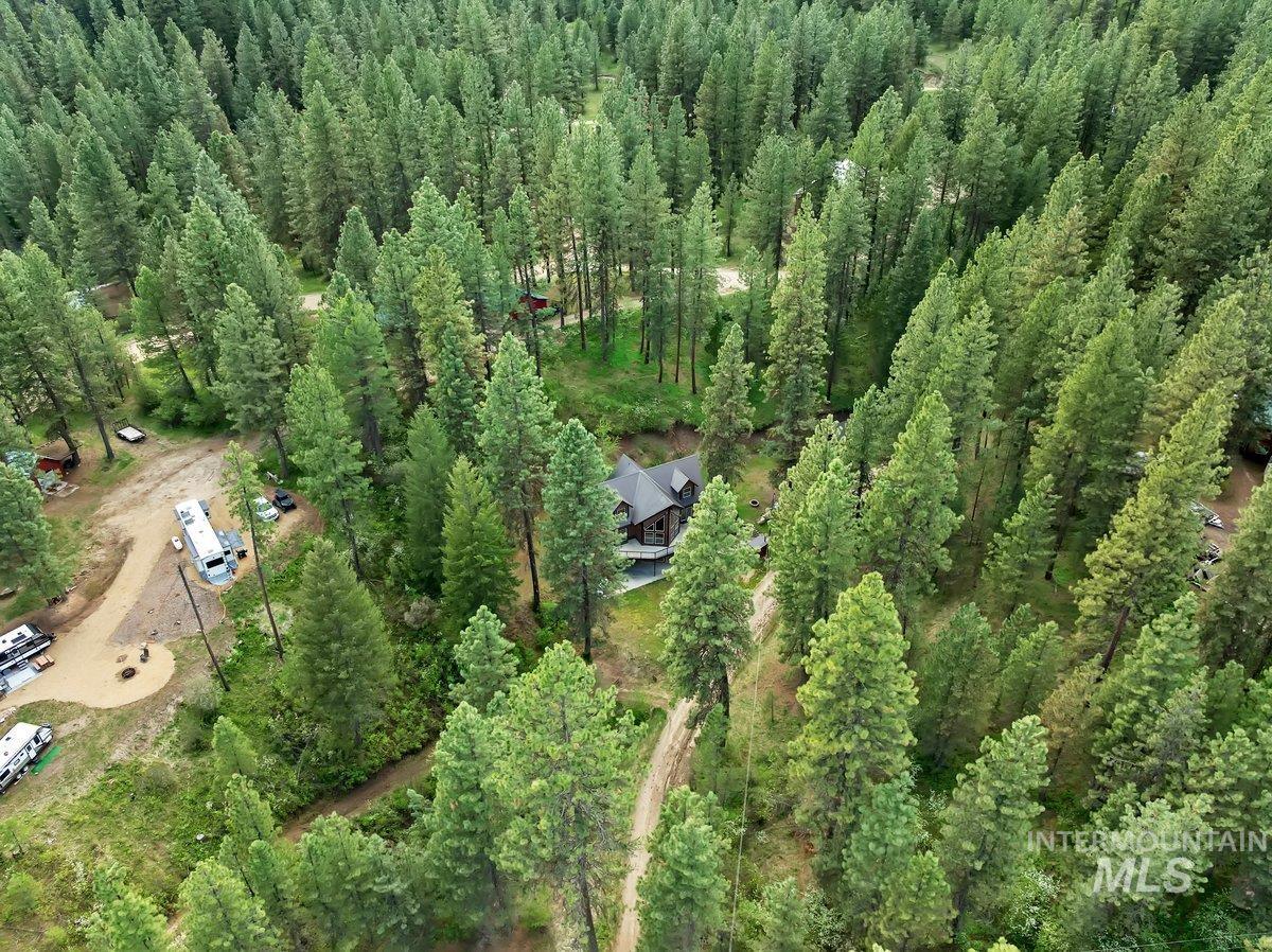 Aerial overview of property's location featuring a forest