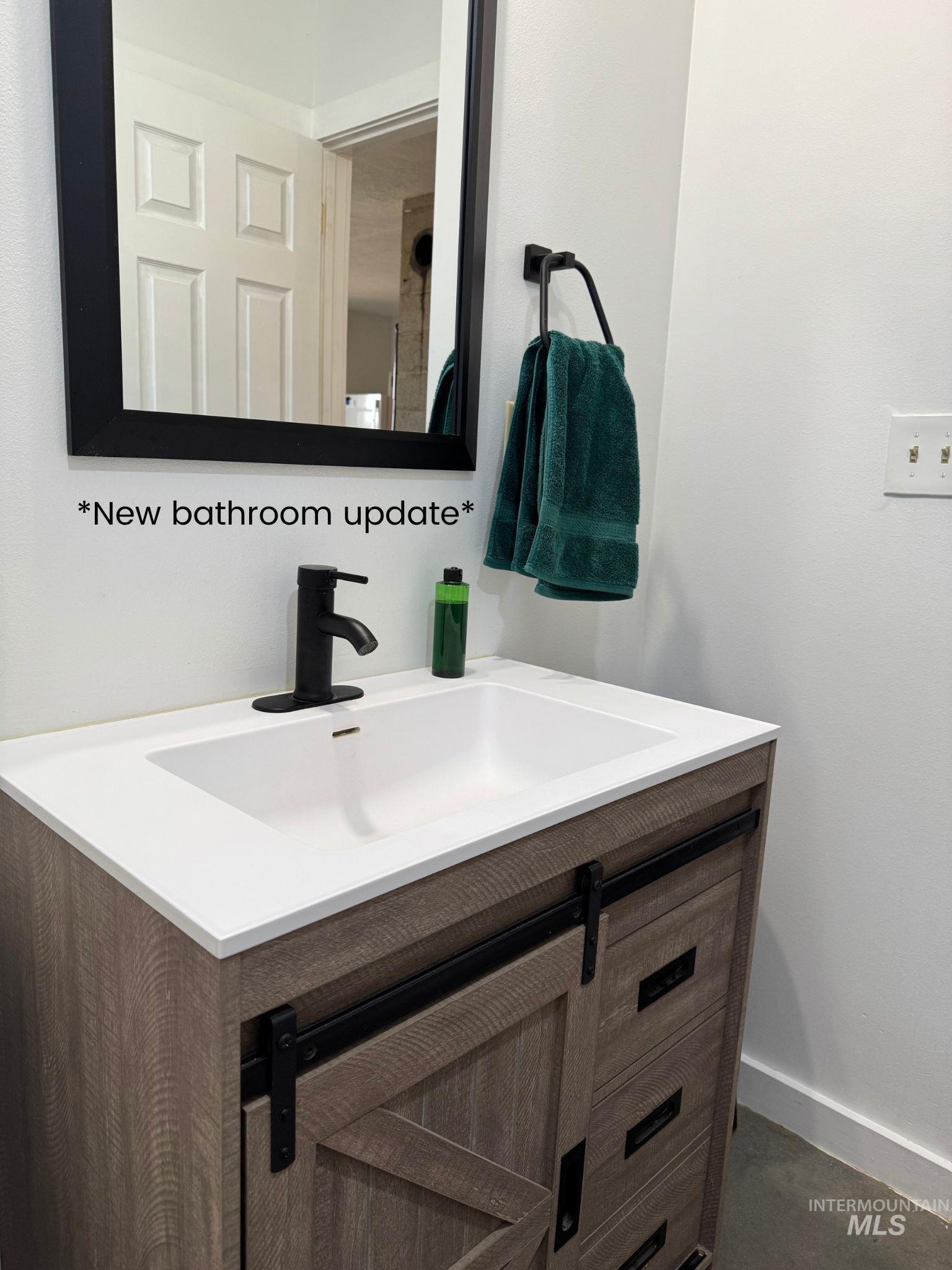 Bathroom with vanity and baseboards