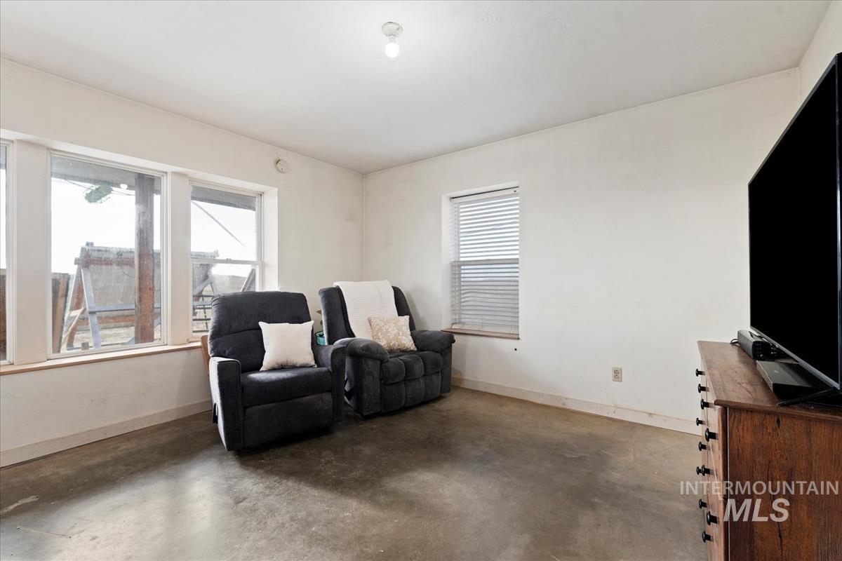 Living area with concrete flooring and baseboards