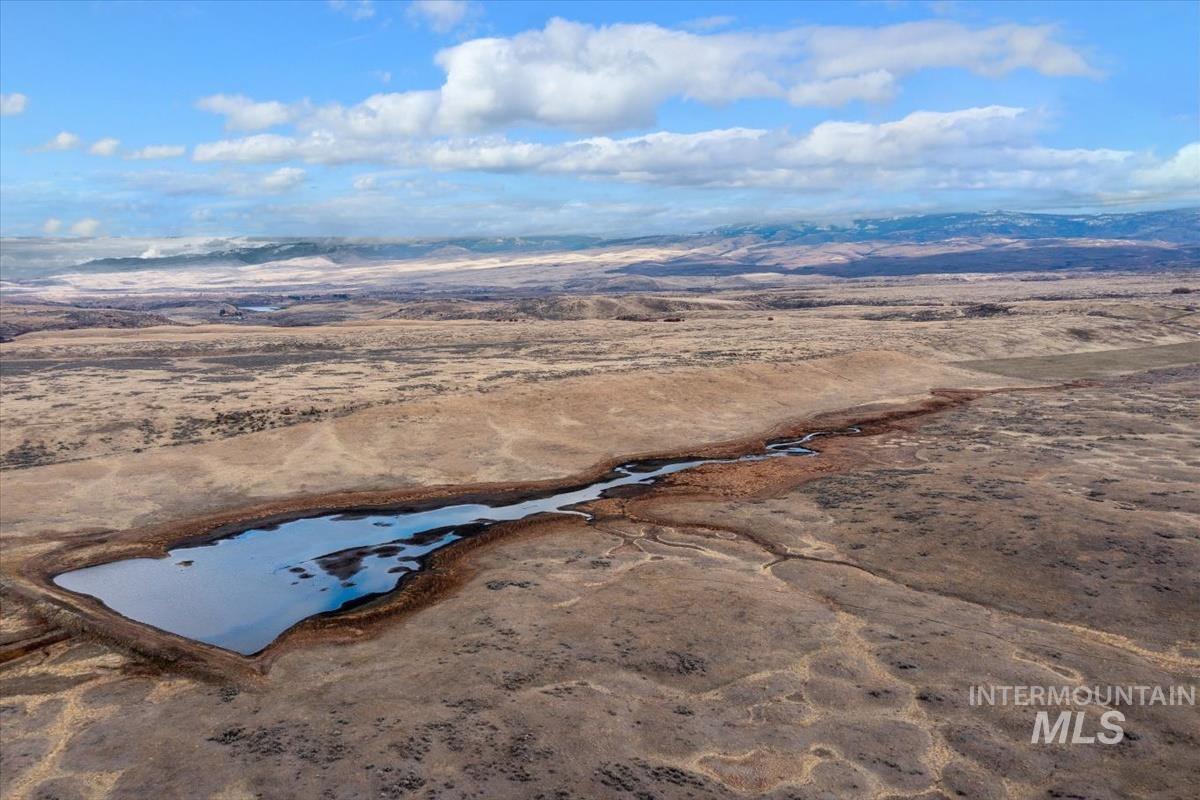 Aerial view of property's location with rural landscape and mountains