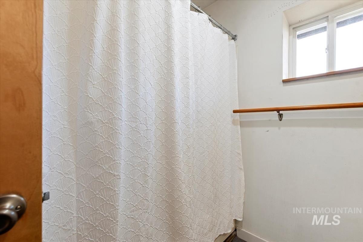 Bathroom featuring a shower with curtain