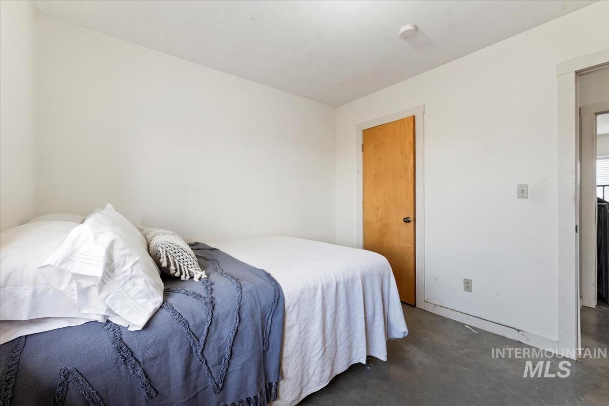 Bedroom featuring concrete flooring