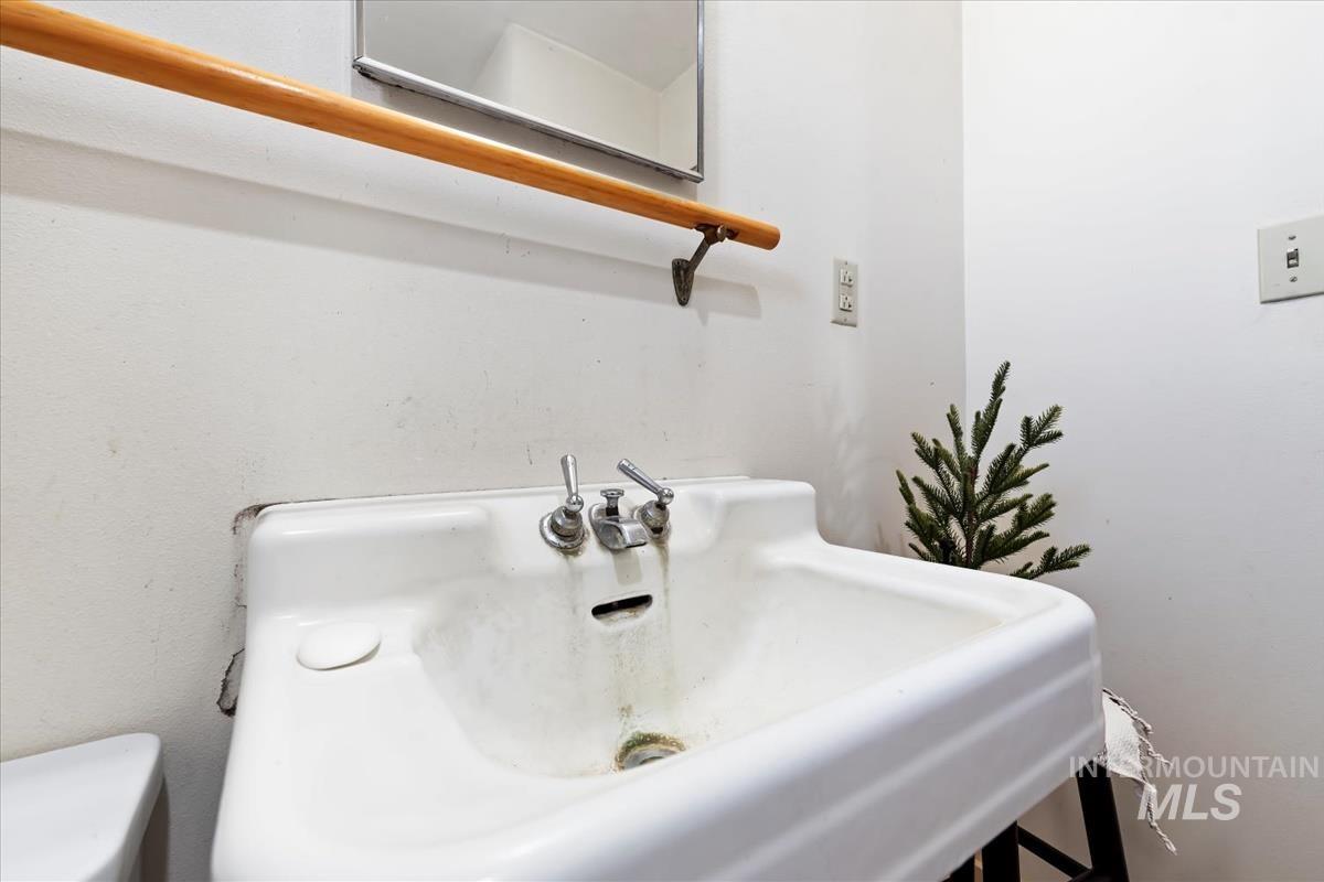 Half bathroom featuring a sink and toilet