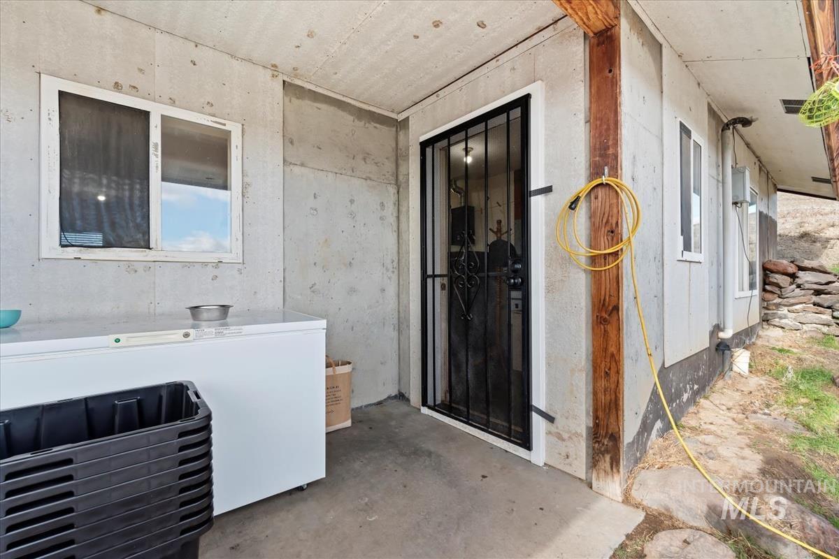 Miscellaneous room featuring unfinished concrete floors